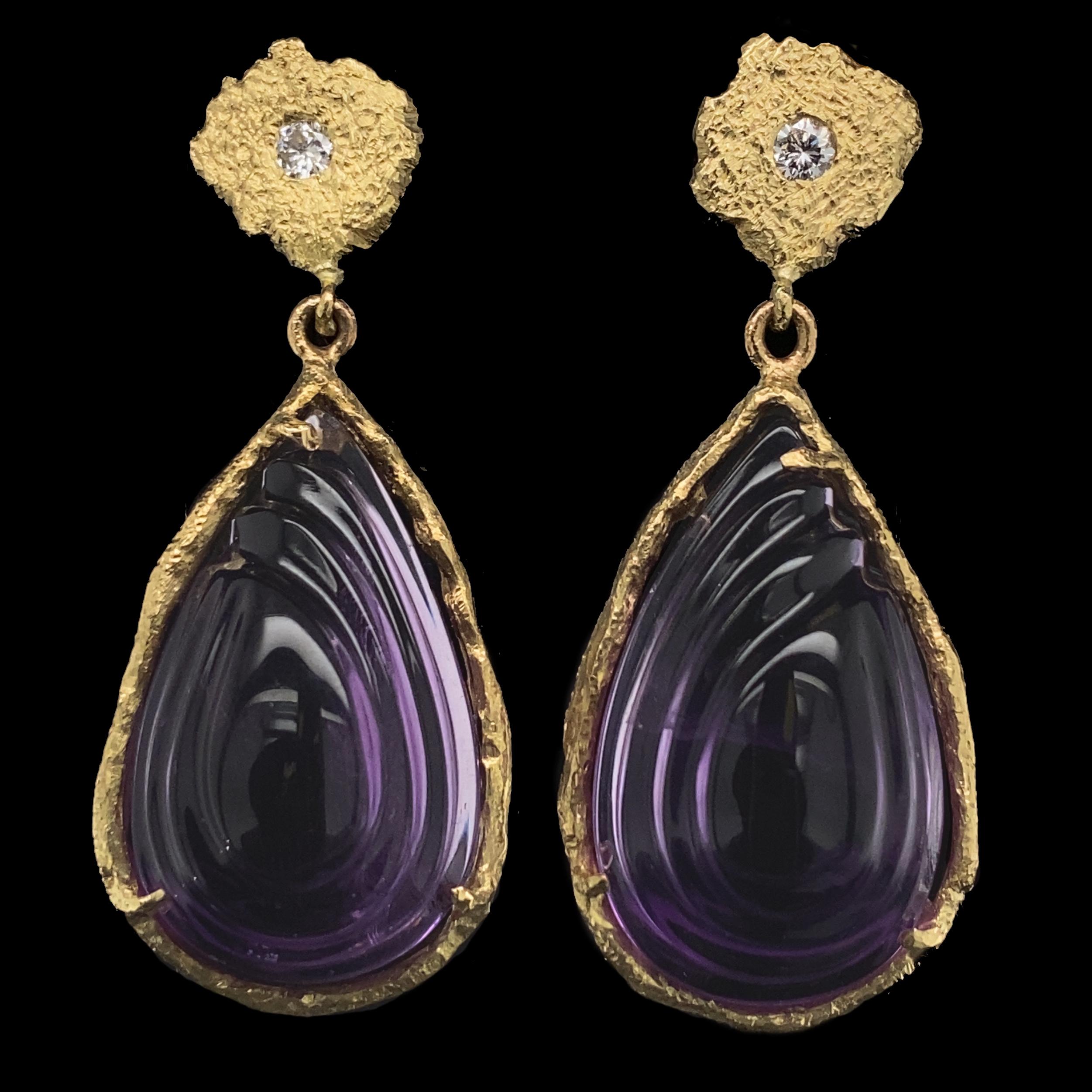 Eytan Brandes bought a trio of carved amethysts (cut for earrings and a pendant) at a trade show several years ago.  Originally, he intended them as a matched set with a lot of diamonds, but he never got around to it and eventually put the project