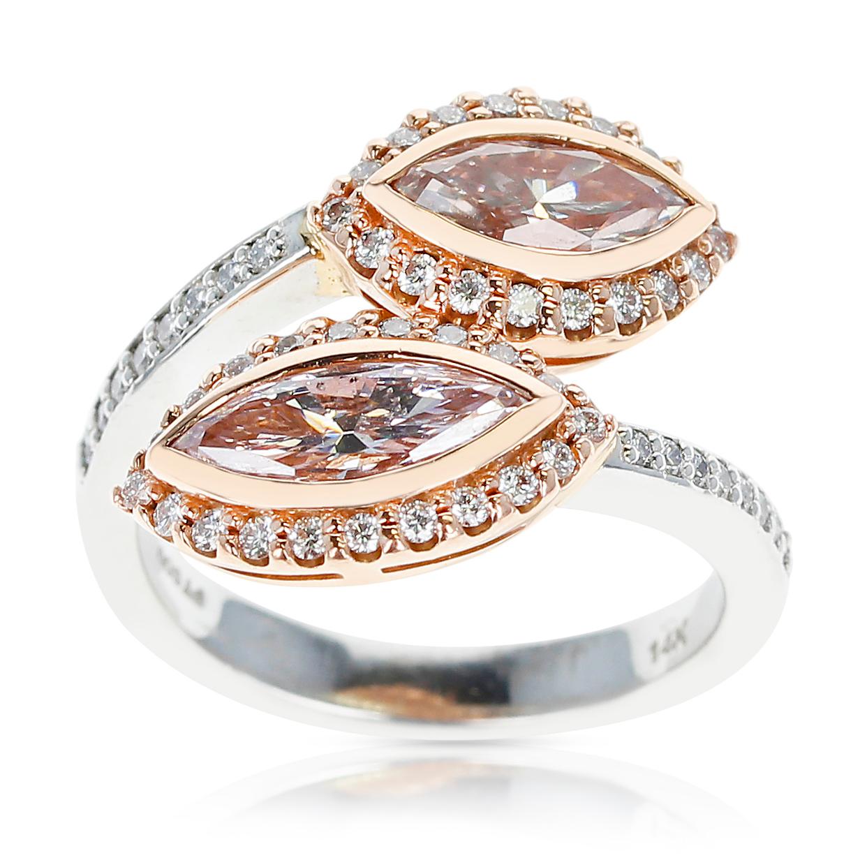 A stunning Twin Marquise Pink Diamond Ring accented with Pink and White Round Diamonds. Ring Size US 7.25. Total Weight: 9.32 grams. Made in 14 Karat Gold. 