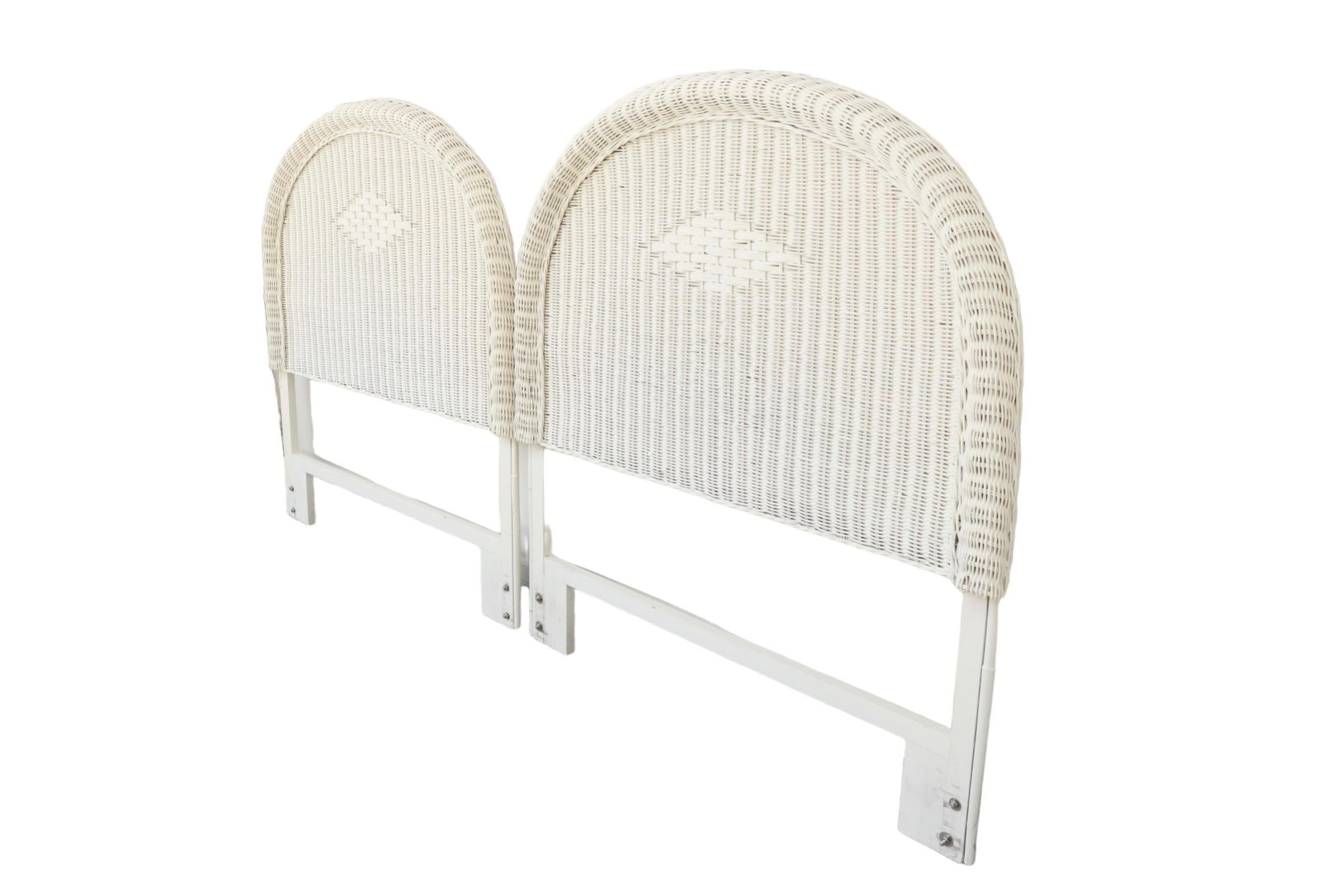 A pair of Heywood Wakefield style twin size rattan headboards. Bentwood frames support woven rattan in a gentle arched shape. Decorated in the center with a traditional Heywood Wakefield style diamond and finished with a rope-twist trim. Painted
