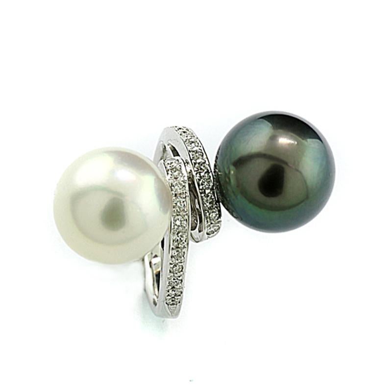 An extraordinary pearl ring featuring a South Sea cultured pearl,  11,6 mm diamater, round shape, silvery white color with overtones of delicate rose and silver, fine luster, smooth surface with only subtle typical growth marks, and a Tahitian