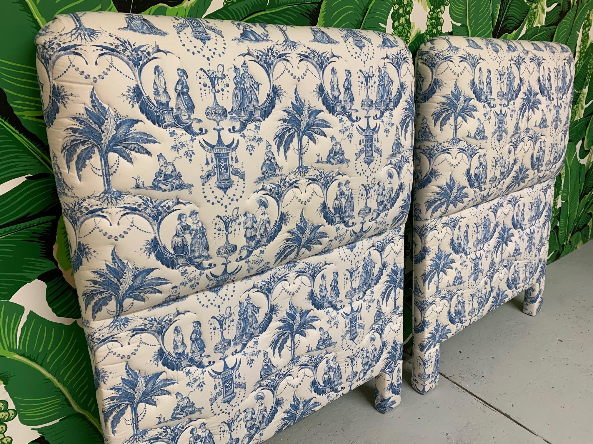 Pair of twin headboards upholstered in blue and white Asian chinoiserie style fabric featuring palm trees, pagodas, and Chinese characters. Very plush with thick cushioning. Very good condition with no stains, tears, or odors.