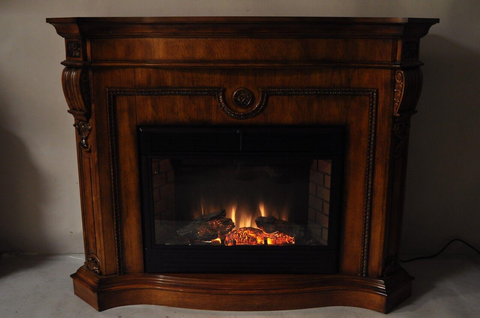 Heavy solid wood construction, nicely carved details, working heater and lighted fireplace with various settings, large impressive size, great style and form. Circa 21st Century, Pre-owned. Measurements: 48