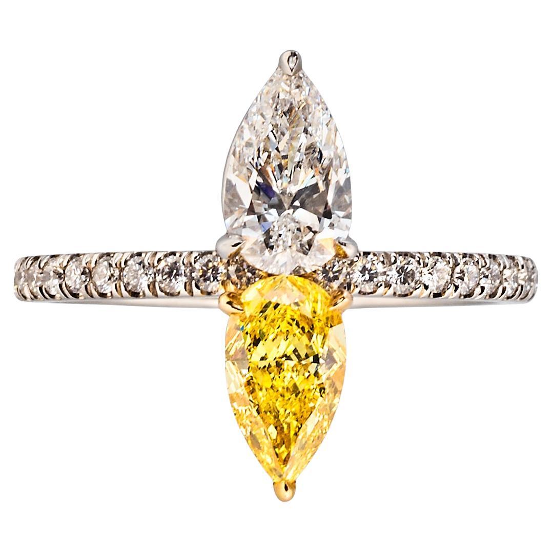 A 0.67 fancy intense yellow pear modified brilliant-cut diamond and a 0.62 carat pear brilliant-cut diamond with round accent diamonds, mounted in 18k yellow gold and platinum 

Size 5-3/4, can be resized 
2020 GIA report no. 6355043948: 0.67 carat,