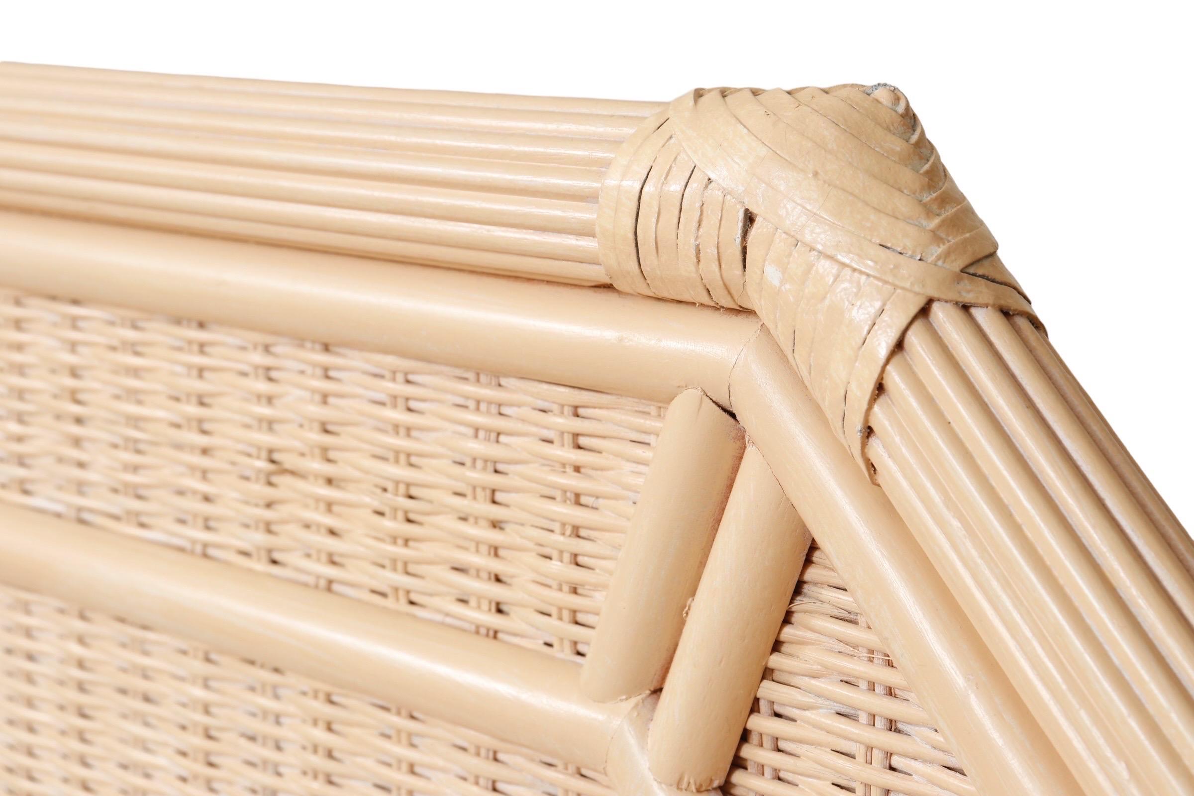 A pair of twin-size tan wicker headboards. A border of beveled wooden panels frames the wicker headboards, set in reeded bamboo frames secured with leather wrapping. Dimensions per headboard.