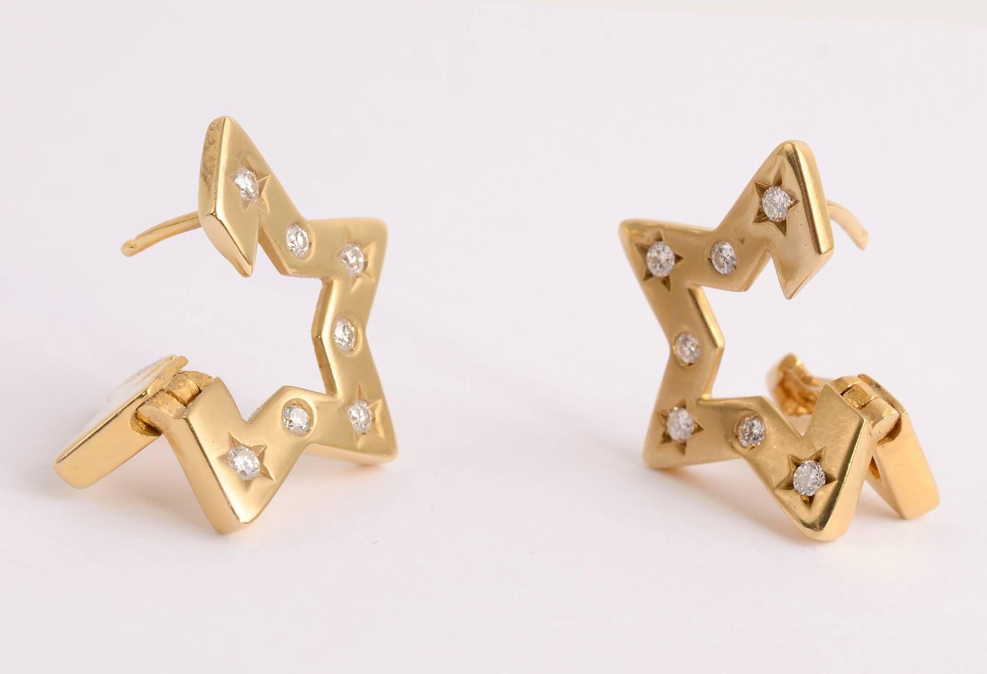 Three dimensional 18 karat gold star earrings, each with seven diamonds. The diamonds are all round but four in each earring are set in a star. Backs are posts. There is a maker's mark with which I am not familiar. It is a star with 690AL. 