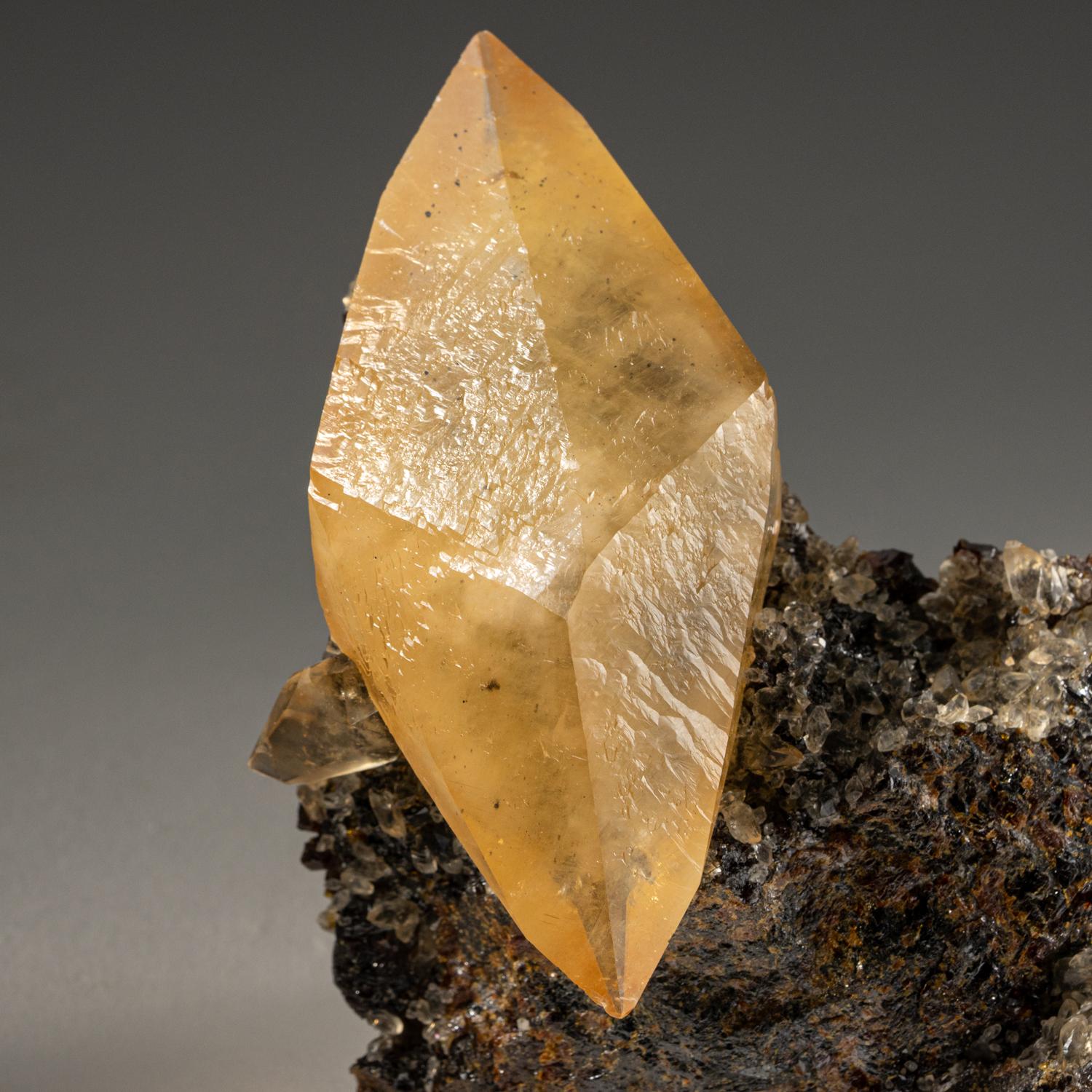 Lustrous transparent deep golden calcite crystal on small sphalerite matrix. Large double terminated scalenohedral twinned on the C-axis with well defined re-entrant faces, with sub parallel crystal growth. The golden calcite crystal is the perfect