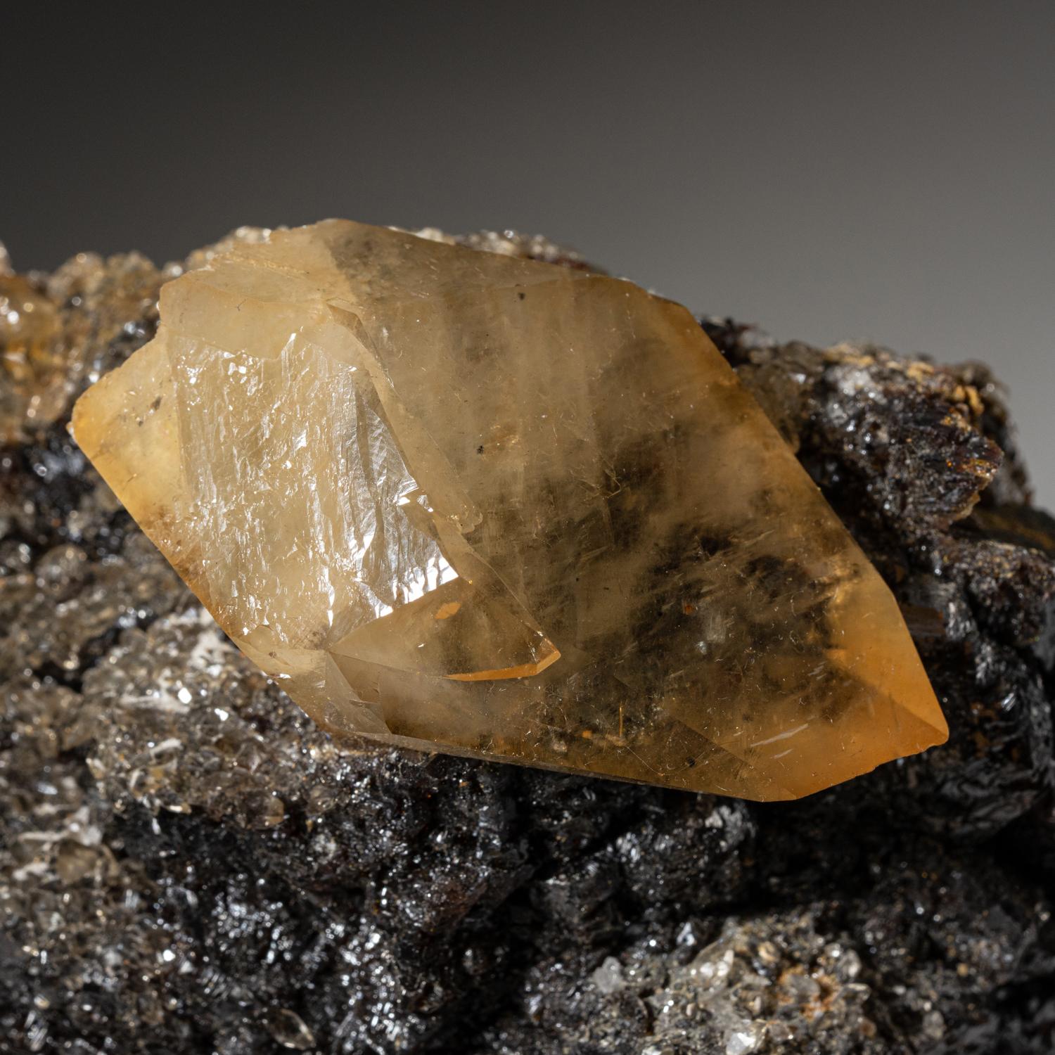 Lustrous transparent deep golden calcite crystal on small sphalerite matrix. Large double terminated scalenohedral twinned on the C-axis with well defined re-entrant faces, with sub parallel crystal growth. It's an exquisite example of twinned