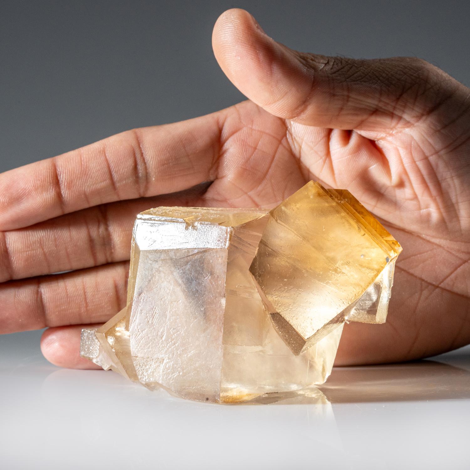 Penetrating twinned crystals of transparent golden yellow calcite with silky luster faces and sharp terminations. The twin orientation is well defined and visible throught the termination faces.

 

Weight: 370 grams, Dimensions: 2.5 x 2.5 x 2.5