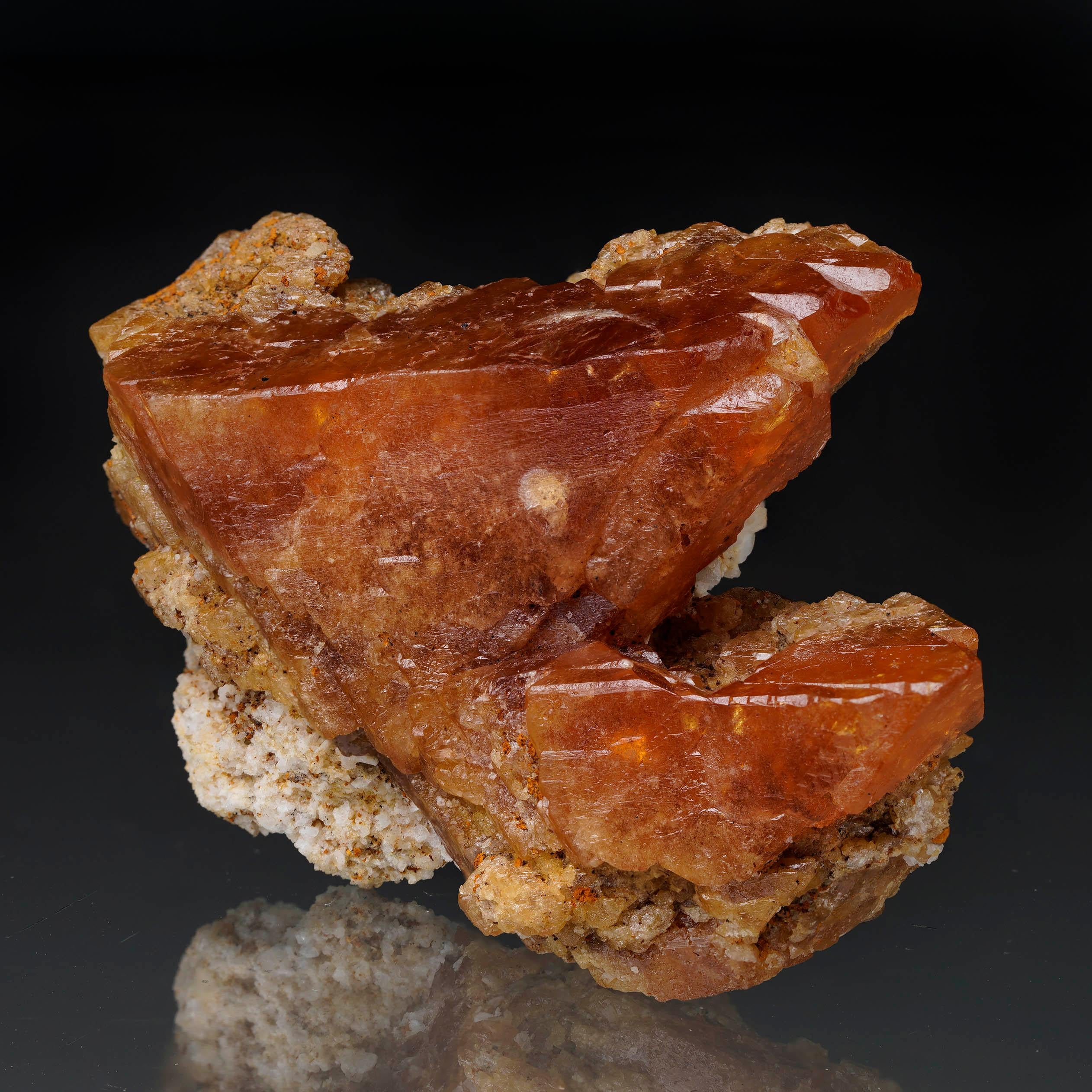 This vibrant Scheelite specimen out of China features two sharply defined, lustrous, bold orange crystals with deep internal glow and natural translucency twinning side by side in spectacular display. Not only the rare crystal formation but also the