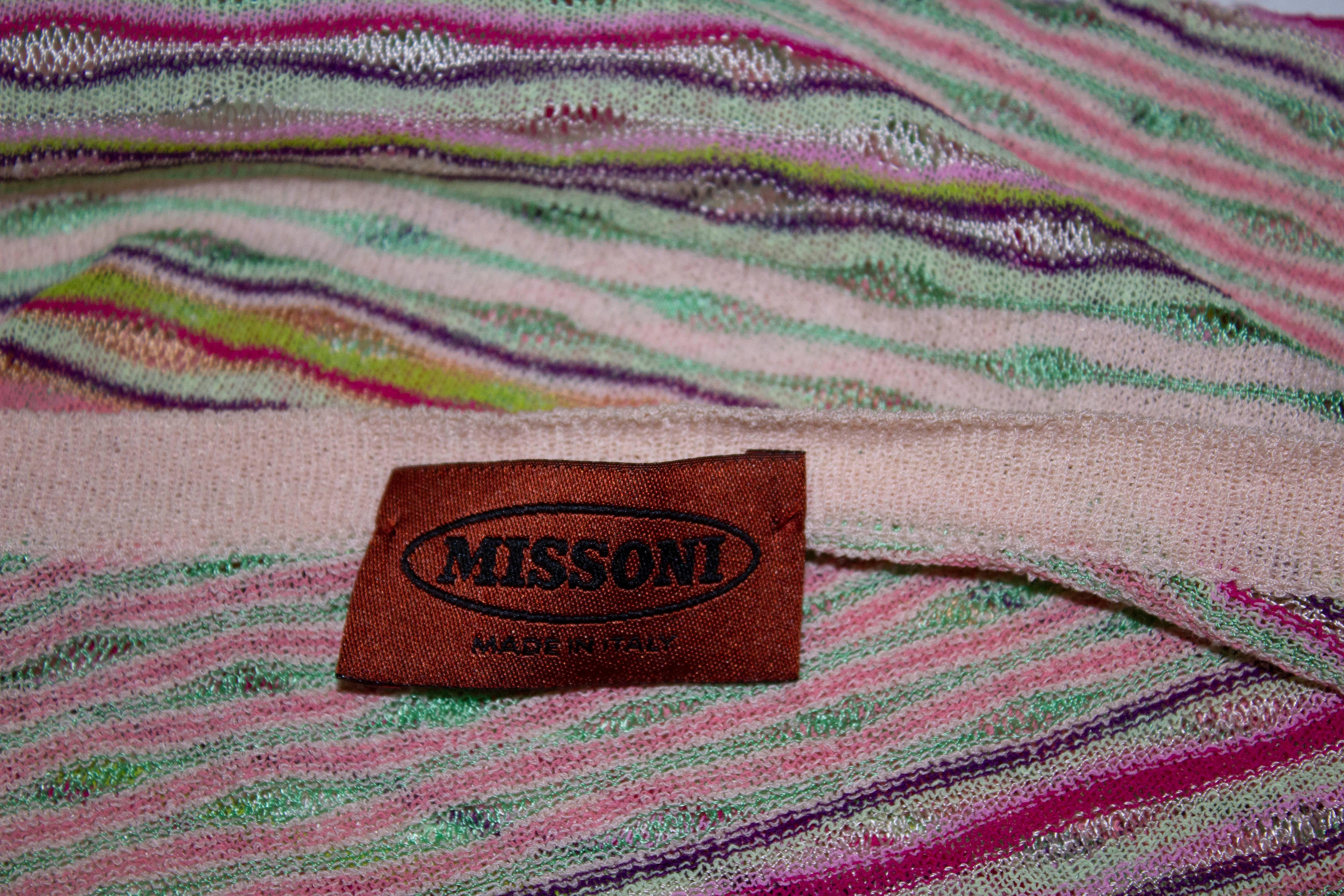A pretty twinset by Missoni , main line /brown label. The cardigan has a v neckline with a four button opening. 
The set is in a mix of pretty spring colours, the top has cap sleaves with a v neckline and string /tie detail.
Both labelled size 42 ;
