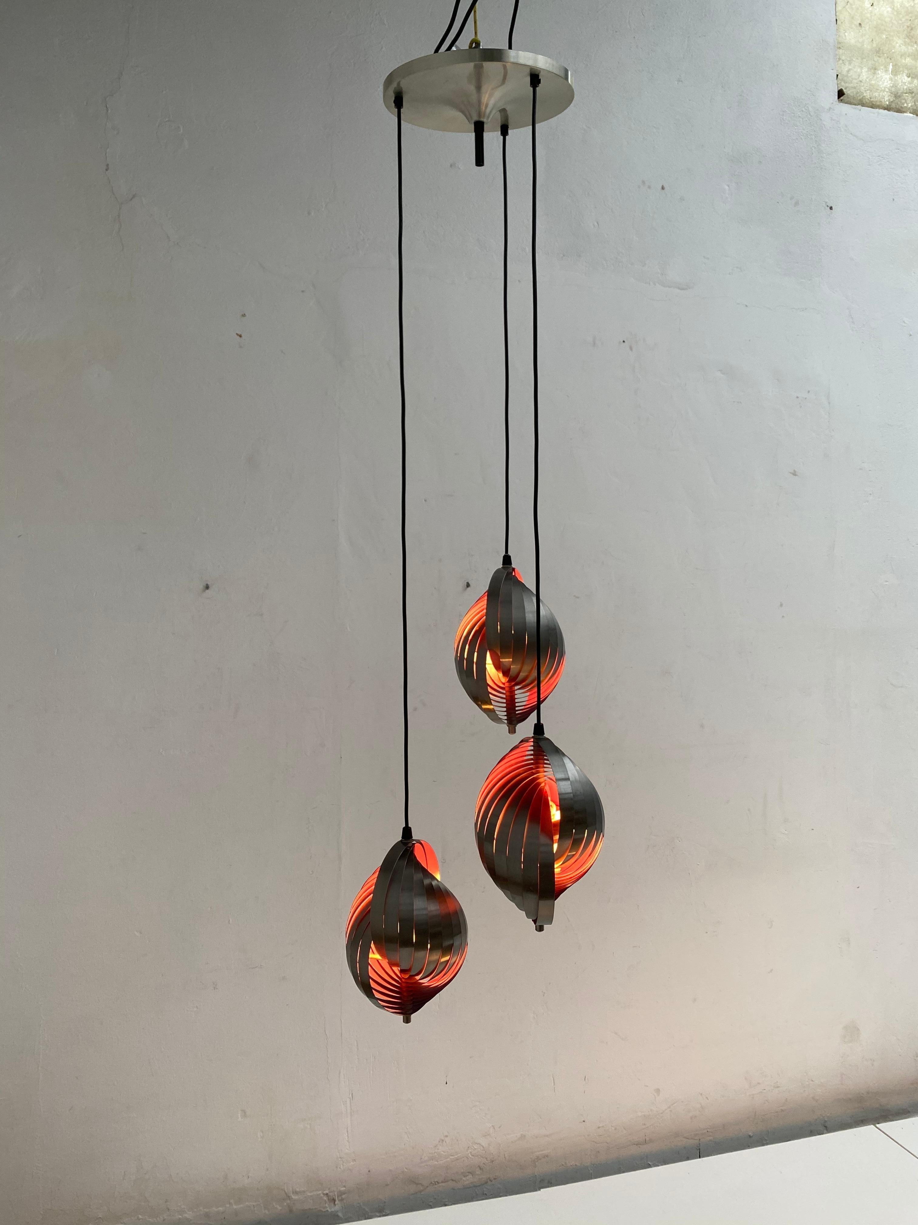 Ceiling fixture by French designer Henri Mathieu for Lyfa, Denmark, circa 1970

3 brushed stainless steel pendants with purple enameled interior that give this fixture a fabulous effect in the dark

Each pendant contains 2 E14 bulb sockets so 6