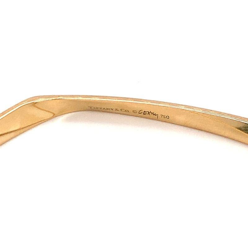One 3-D twist 18K yellow gold square Torque bangle bracelet by Tiffany & Co. / Frank Gehry measuring 4 millimeters wide. Stackable gorgeous piece with impeccable make.

Well-built, modern, sleek.

Additional information:
Metal: 18K yellow