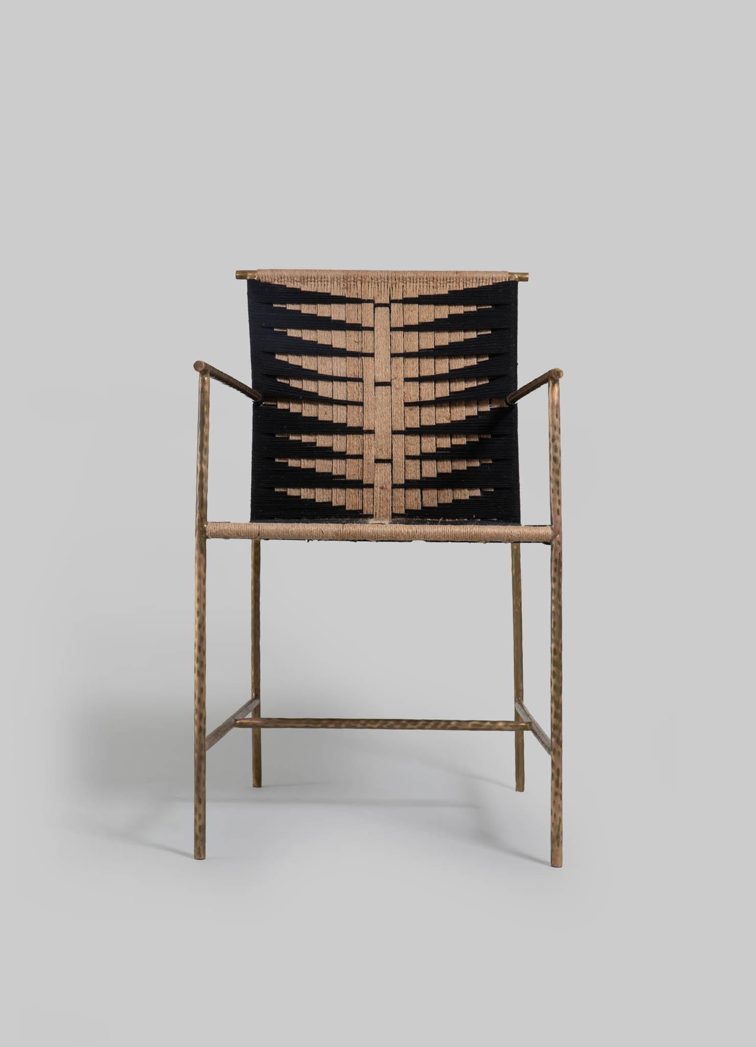 Twist and Knot Black Natural Chair in Rope and Brass legs, Viya by Vikram Goyal

Immersed in the heritage of India's ancient artistry, the humble rope transports us to the heart of craftsmanship. Drawing inspiration from the ubiquitous Charpoy, a