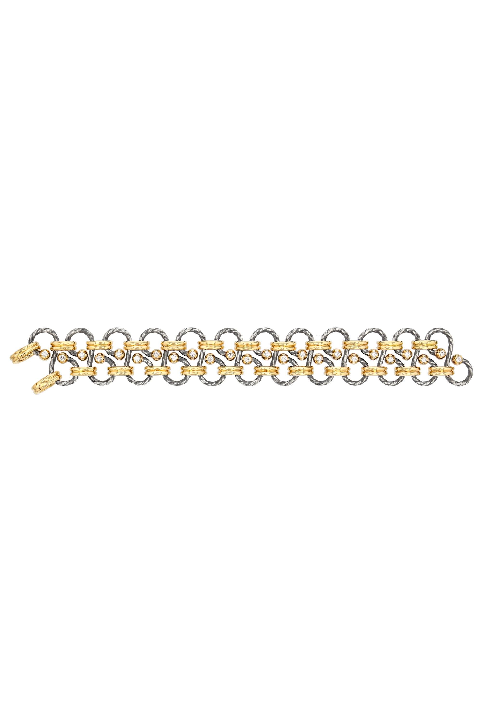Bracelet alternating gadrooned rings of yellow gold and twisted serpentine rings of distressed silver punctuated with gold balls set with a diamond.

Details:
26 GVS Diamonds: 1.04 cts
18k Yellow Gold : 45 g
925 Distressed Silver: 18 g
Made in France