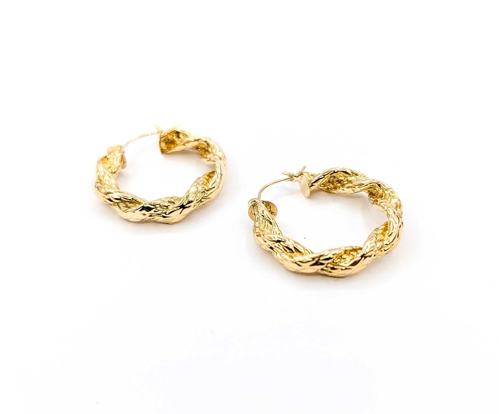 Aggiungi un tocco di consistenza ed eleganza alla tua collezione con questi eleganti orecchini a cerchio a torsione realizzati in oro giallo 14k. Con un diametro di 27 mm e un peso di 3 grammi, il design presenta un motivo lucido e attorcigliato che