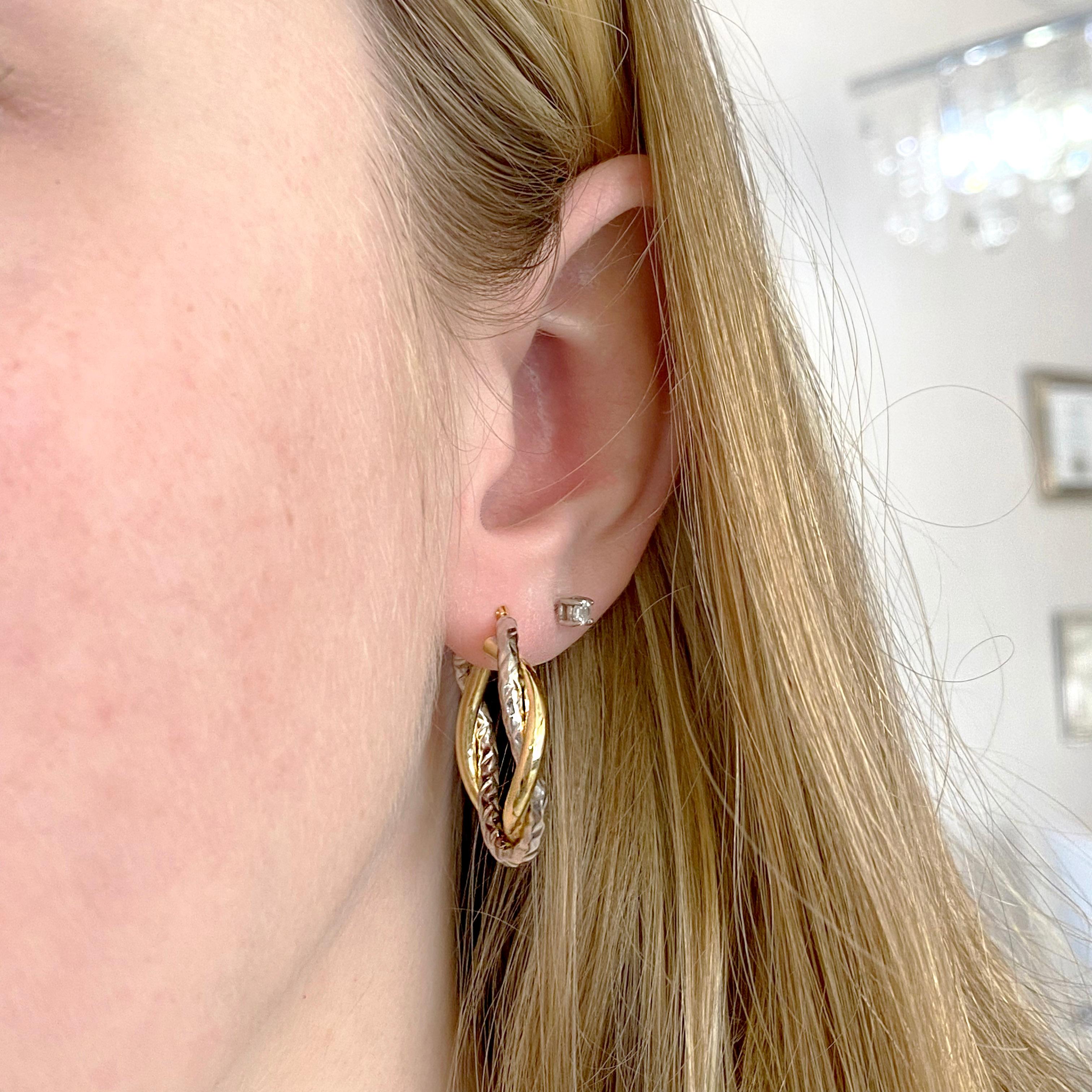 These mixed metal earrings are hoop earrings that are 14 karat white and yellow gold. They will look good with both your white gold and sterling silver and your 10, 14, and 18 karat yellow gold. They have a hinged post that will fit on any earlobe. 