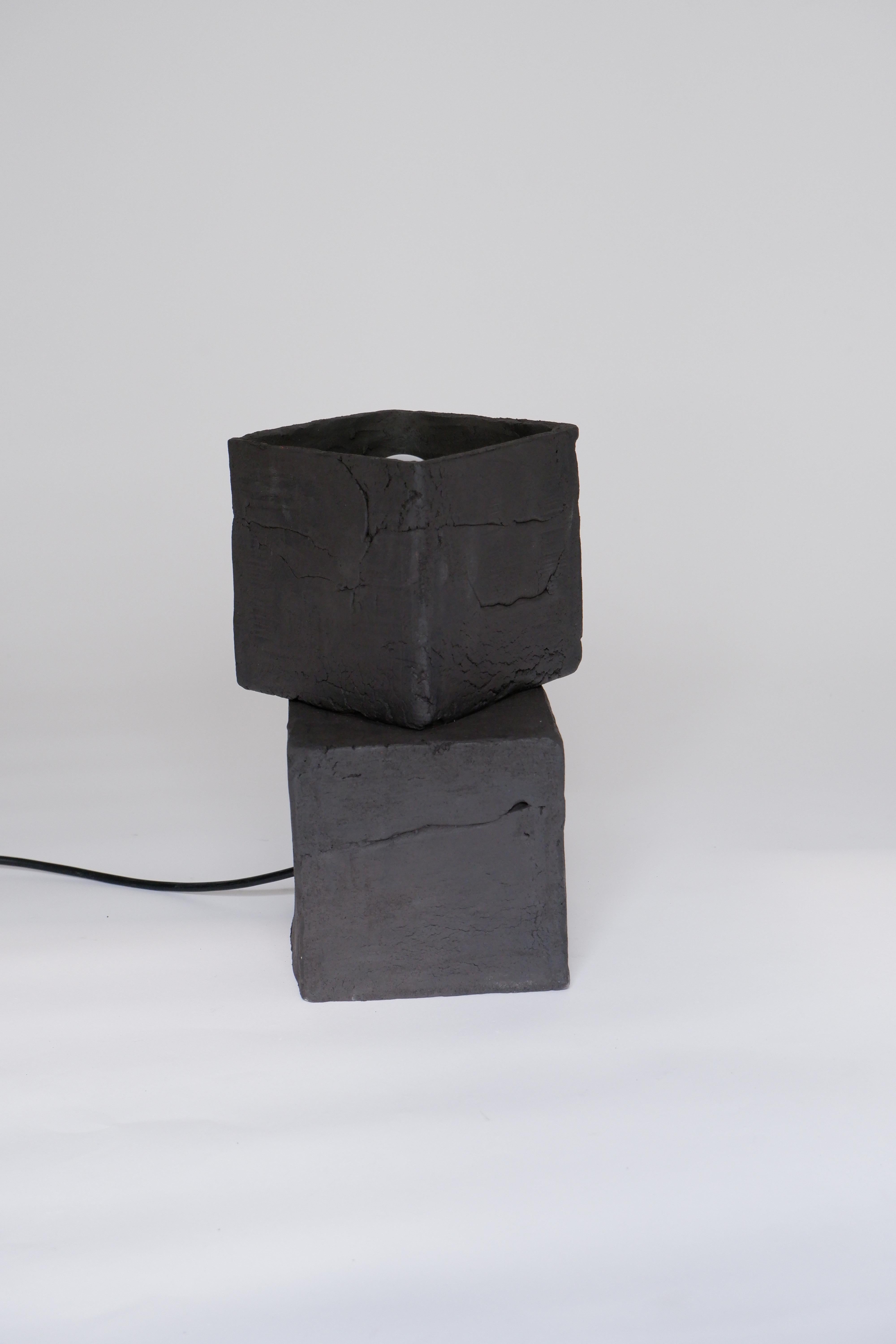 Twist Table Lamp by Ia Kutateladze
One Of A Kind.
Dimensions: D 20 x W 18 x H 26 cm.
Materials: Clay.

Each piece is one of a kind, due to its free hand-building process. Different color variations available: raw black clay, raw white clay and raw