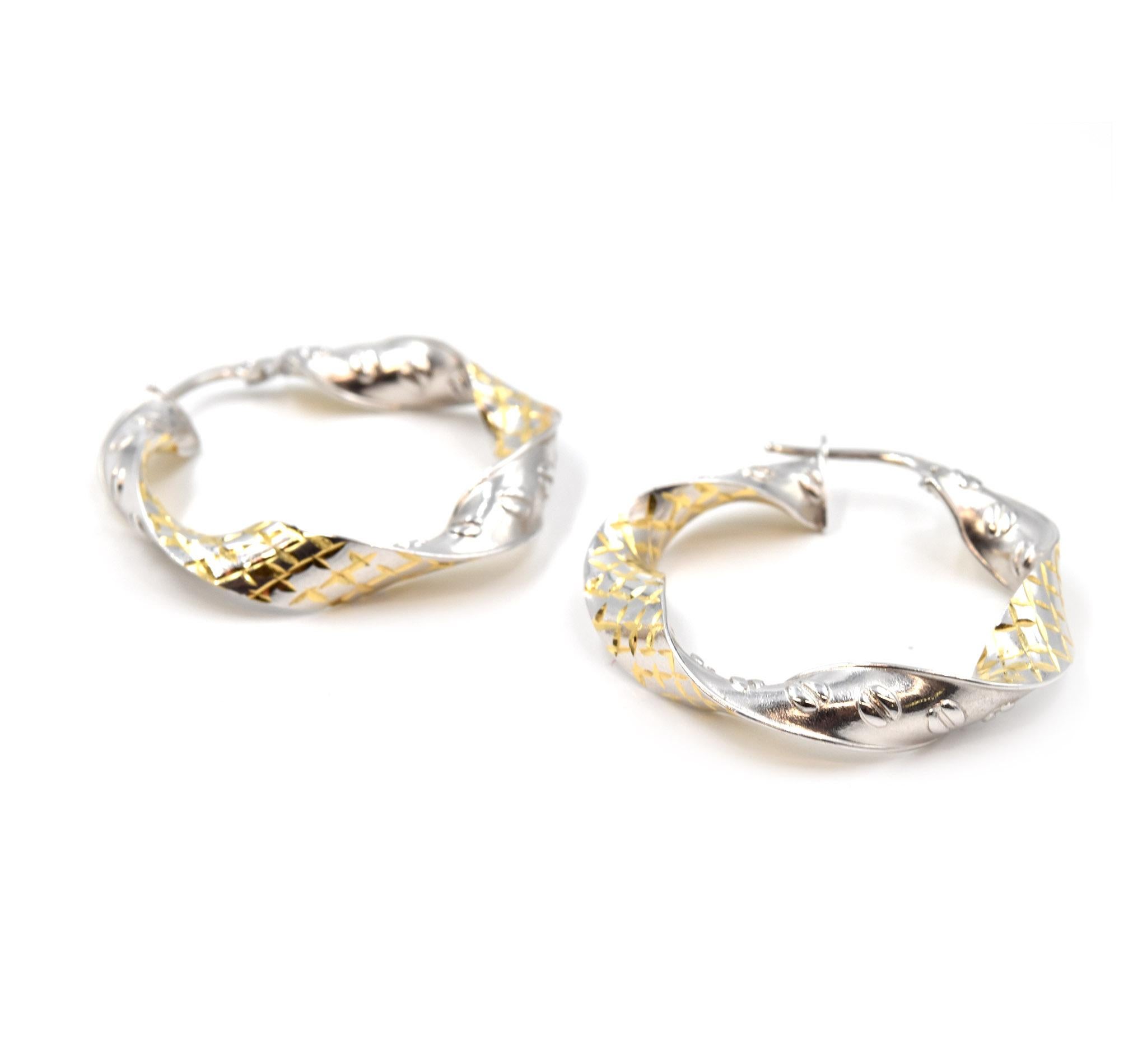 Designer: custom design
Material: 18k white & yellow gold
Fastenings: snap closure
Dimensions: each hoop is 1 1/2-inch long and 1 1/4-inch wide
Weight: 6.09 grams
