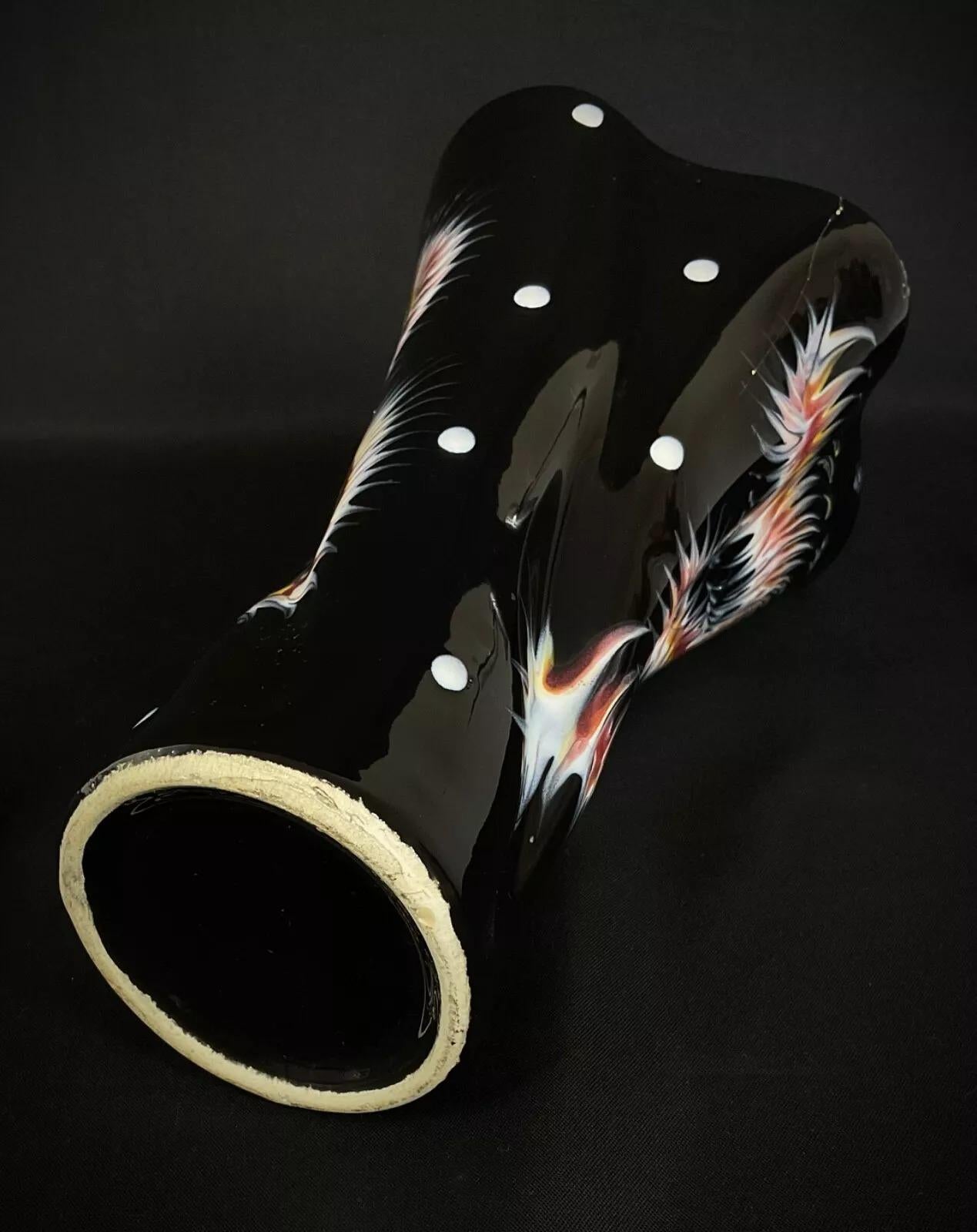 This charming twisted ceramic vase from the late 20th century brings an artistic flair to any setting with its unique shape and multicolored finish. Measuring 21.5 cm (8.5 inches) in height, 18.5 cm (7.3 inches) in width, and 11 cm (4.3 inches) in