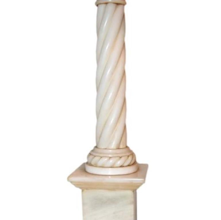 Pair of Italian circa 1940s carved alabaster table lamps with twisted column design and pedestal base.

Measurements:
Height of body 21