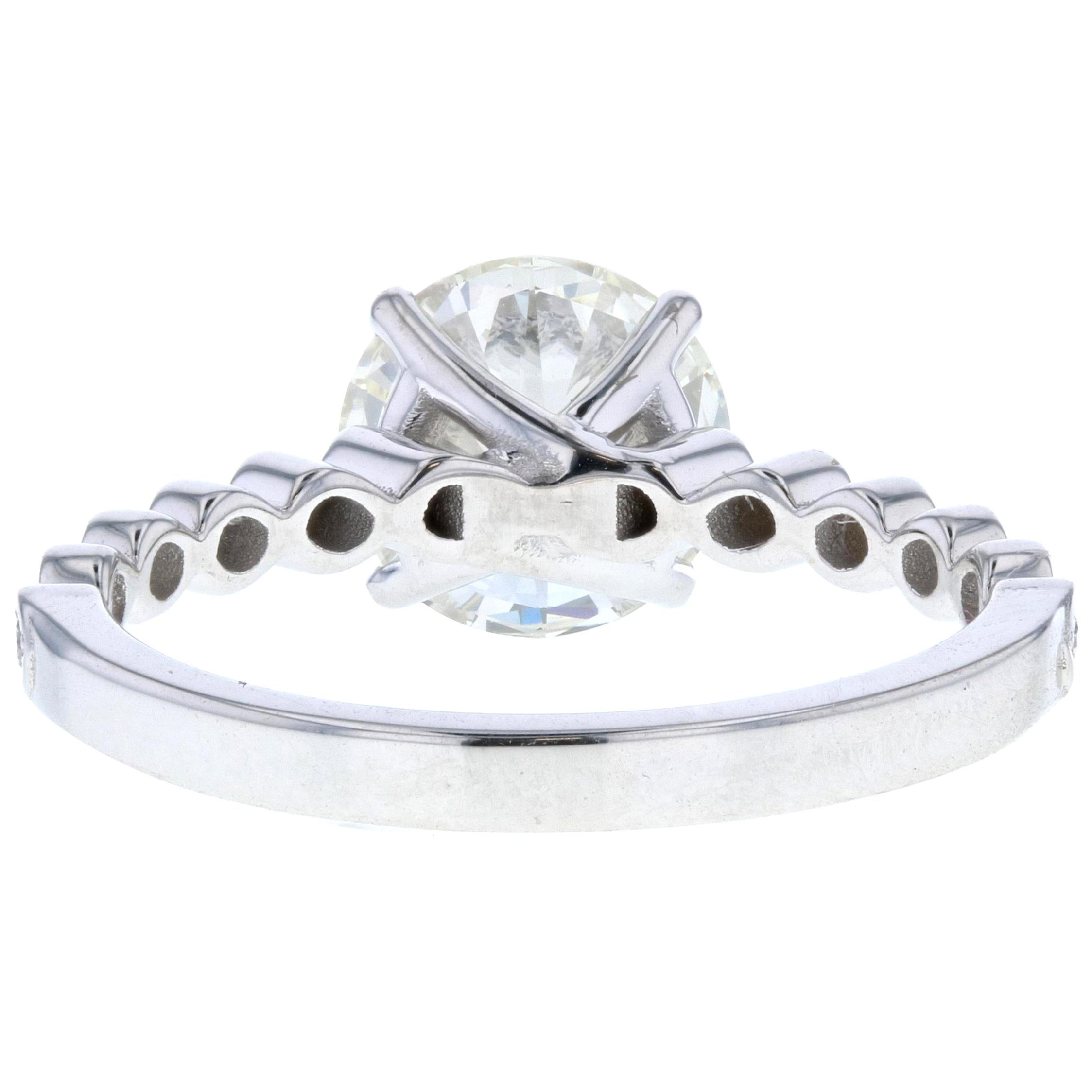 Like diamond pave but want to do something a little different with your engagement ring? Try this elegant design! With a twisted shank covered in diamonds and a beautiful round center stone held in place with eagle claw prongs, this unique