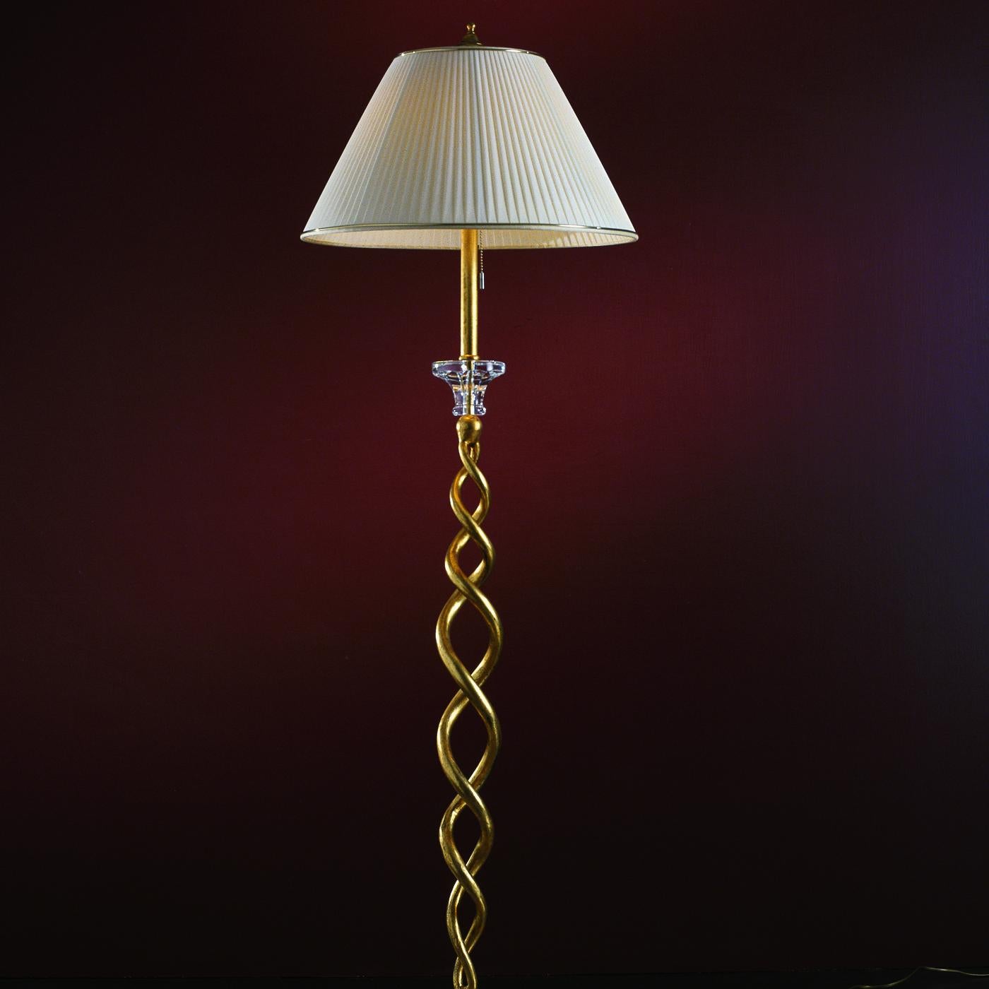 A true masterpiece that will provide ambient lighting in Classic living and dining rooms, while infusing timeless style and elegance, this floor lamp is entirely hand forged of iron with an antique gold-leaf finish. Diffusing the light from a