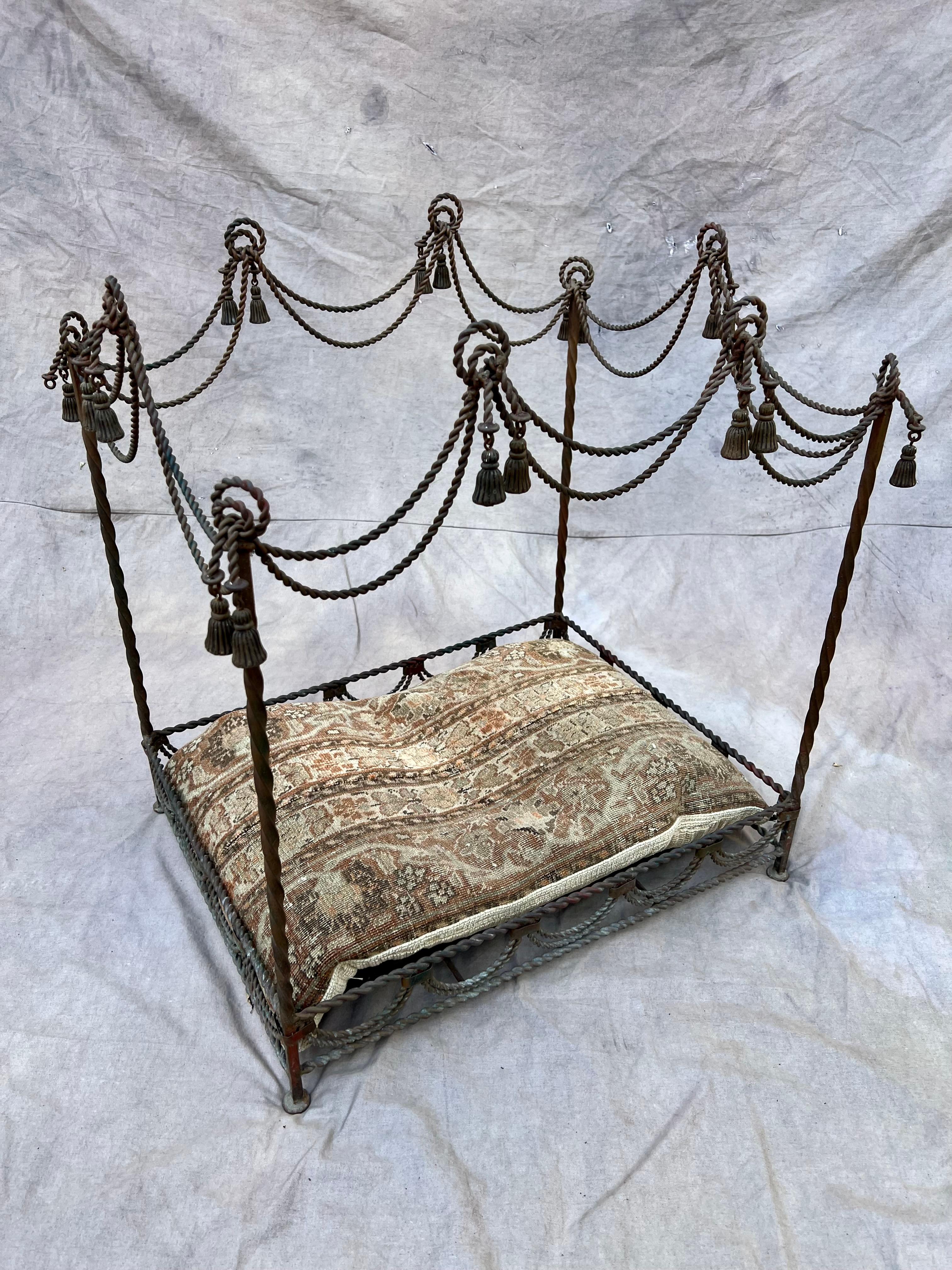 Beautiful twisted iron canopy style dog or cat bed with tassels. Includes a soft, patterned cushion of a durable vintage carpet. A couple tassels missing but nothing offensive or noticeable. The perfect compliment to a lovely bedroom or sitting