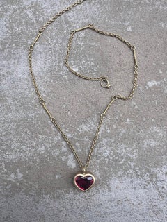 twisted link necklace with 18ct gold set heart shaped ruby