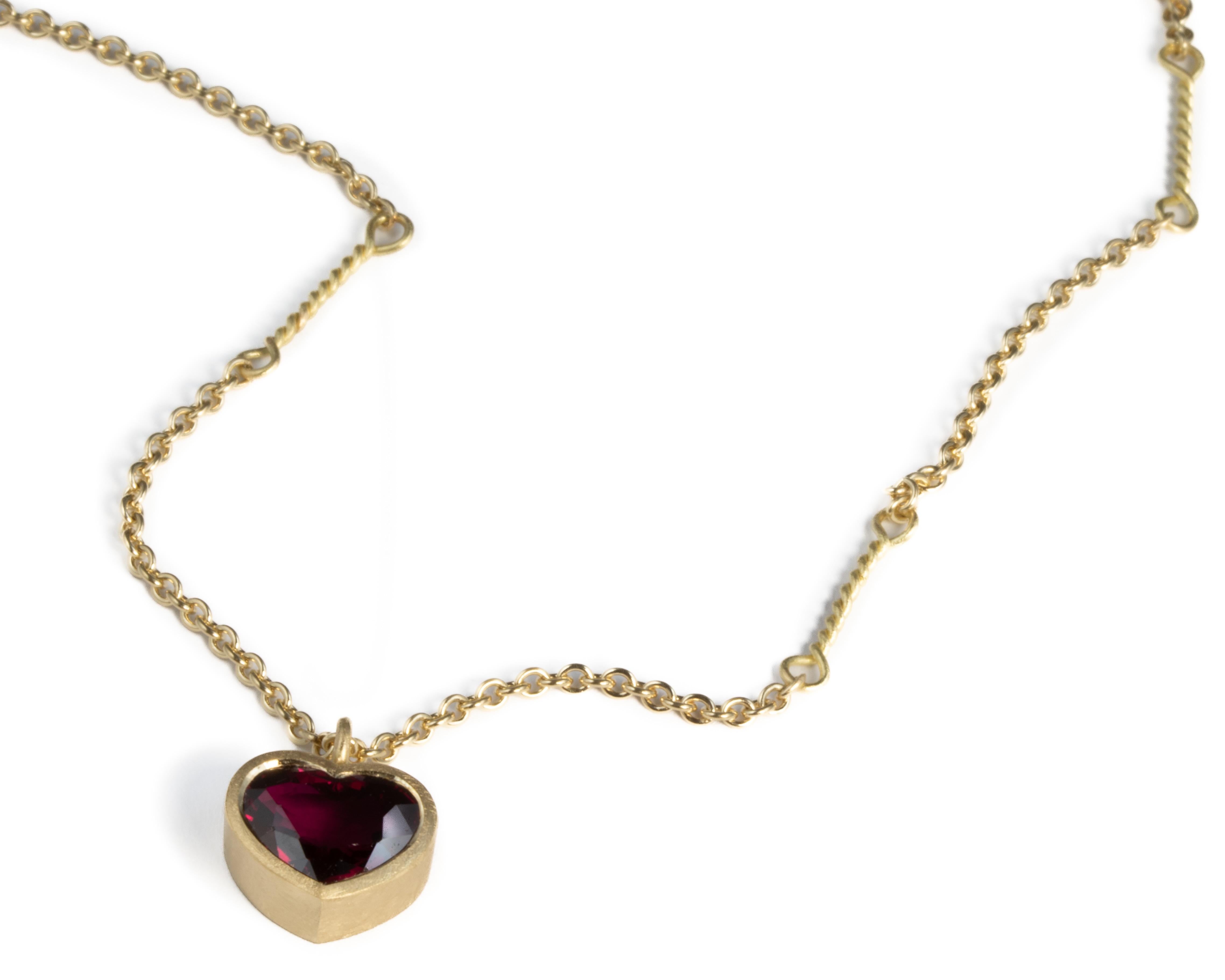 Modern twisted link necklace with 18ct gold set heart shaped ruby For Sale