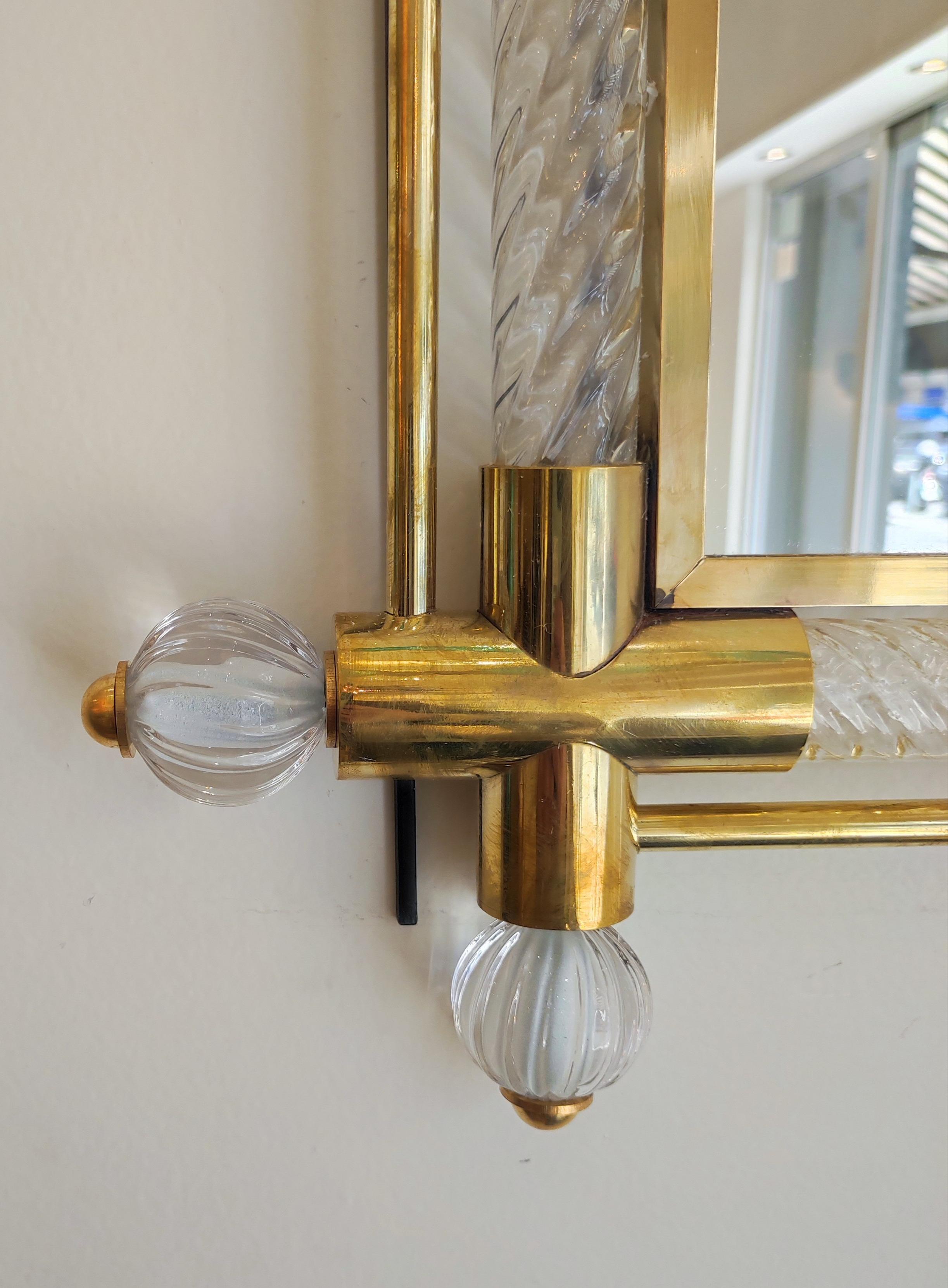 Twisted Murano glass and brass mirror.
(on wood panel)
Measures: 126 cm x 104 cm mirror only 89x64
Height or width position.

One pair available upon request.
 