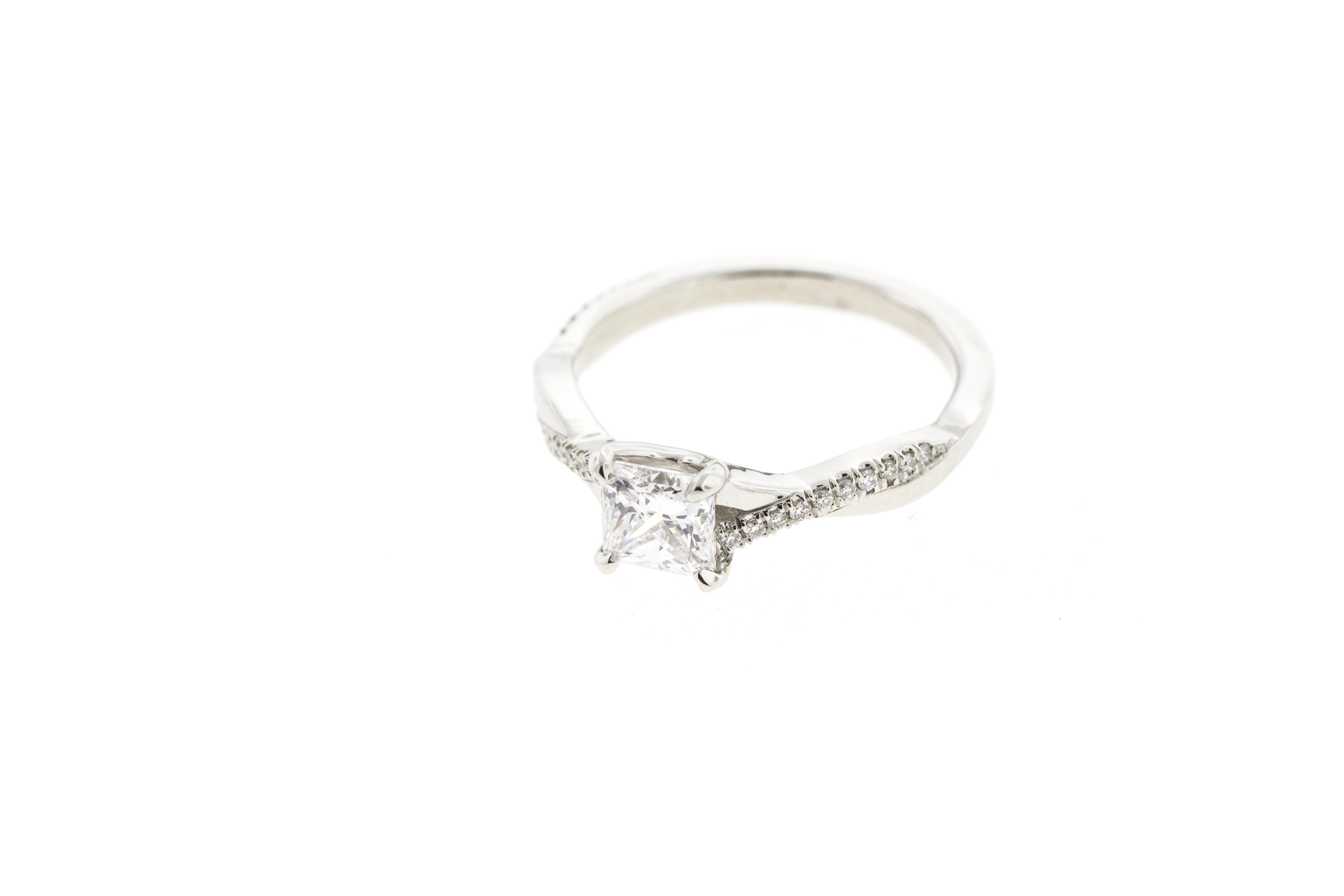 One of our most popular ring designs, with a princess center diamond! This Twisted White Gold Diamond Engagement Ring is crafted in 18KT White Gold and contains a Princess shape Diamond (1.00 total carat weight) with surrounding diamond pave to