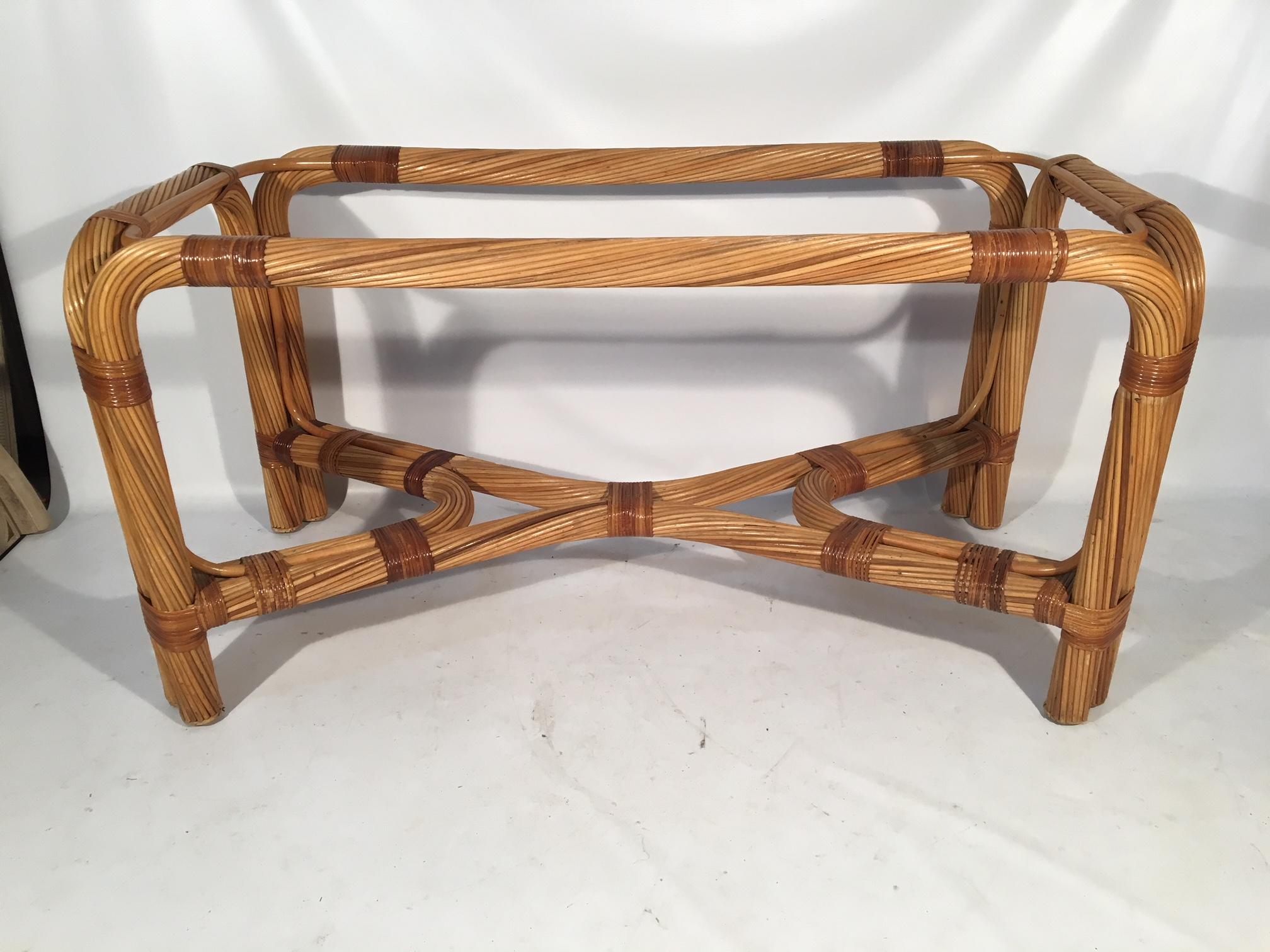 Large twisted rattan table base ready for your glass top. Heavy and structurally sound. Very good condition other than one small section of rattan wrap missing along bottom brace (see photo). Does not detract from table's appearance.