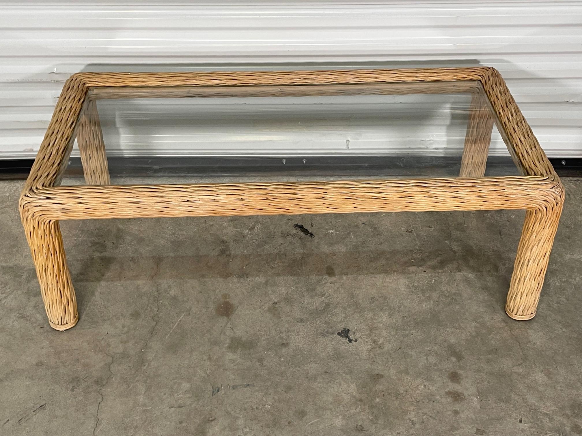 Organic modern coffee table features frame of twisted rattan and glass top. Good condition with imperfections consistent with age. May exhibit scuffs, marks, or wear, see photos for details. We offer professional refinishing services.
  