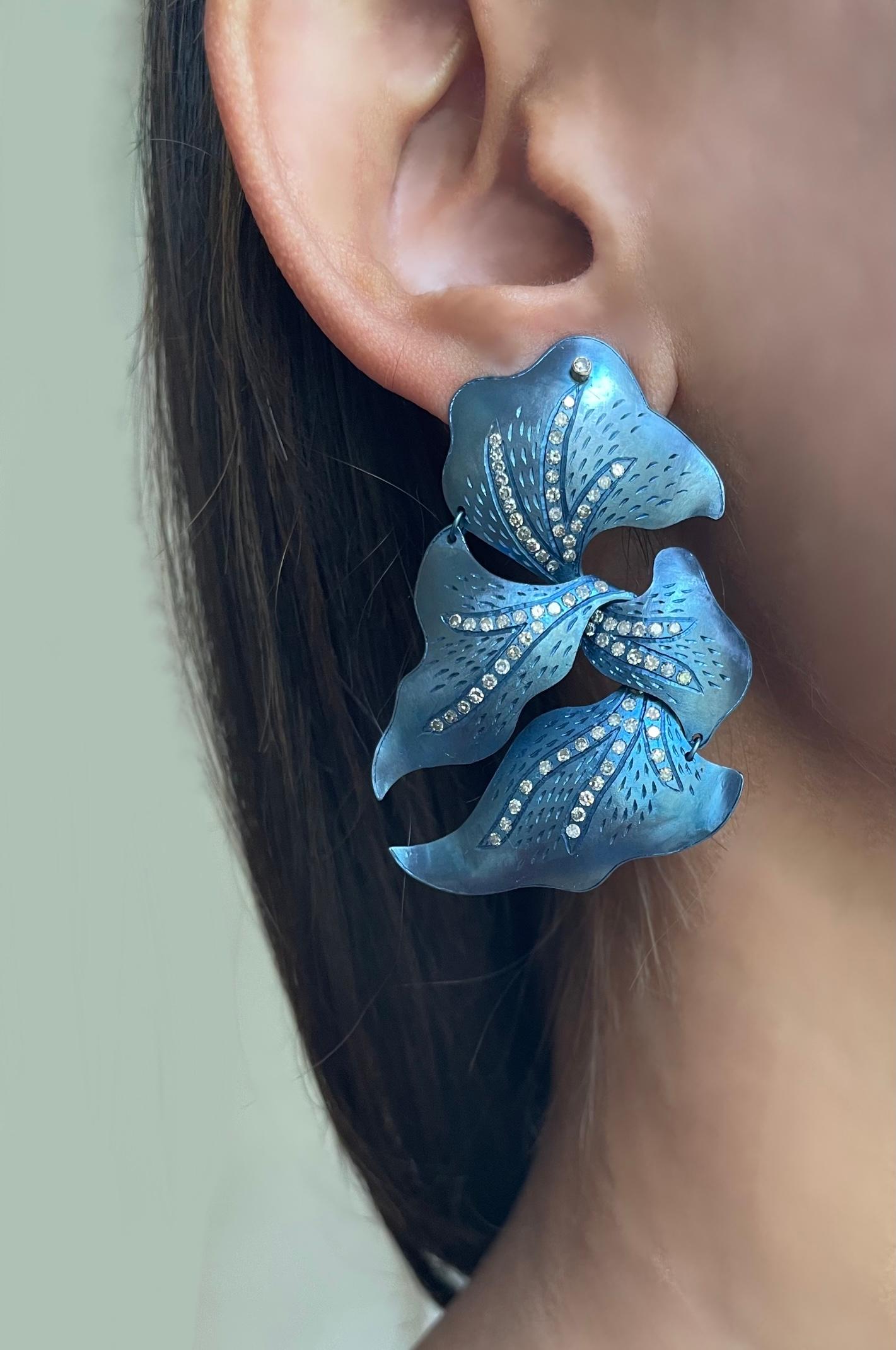 Handcrafted blue twisted titanium earrings with diamonds and 18k gold backs. 

2.17 carats of diamonds. 
18kt Gold backs

