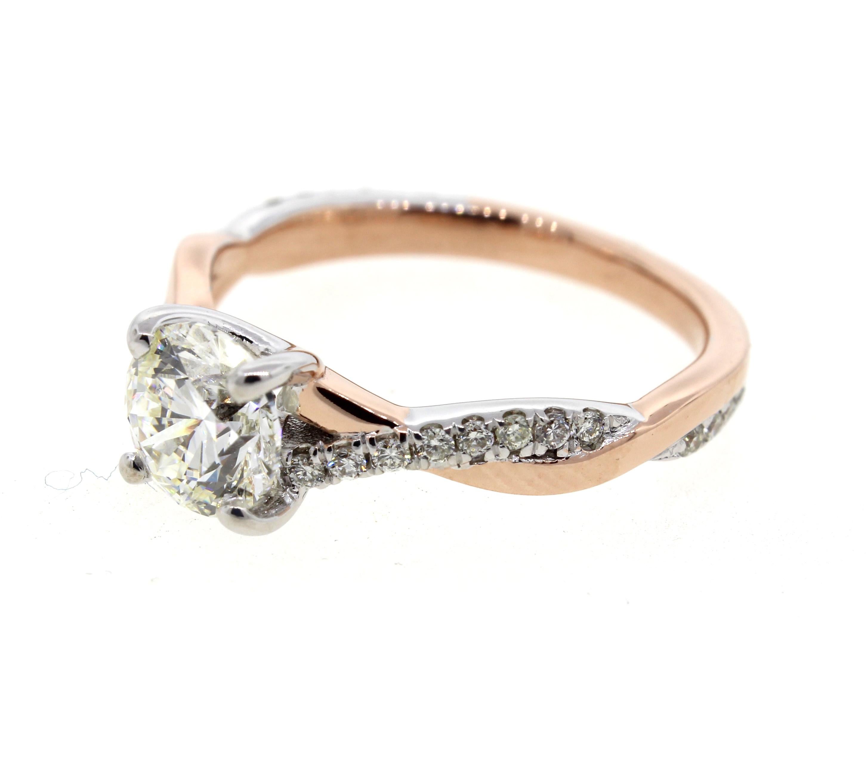 This two tone white and rose gold diamond engagement ring has a twisted rope design and features diamond pave on the band. Combining the best of both worlds, this sweet engagement ring is a perfect combination of all the elements. This ring is