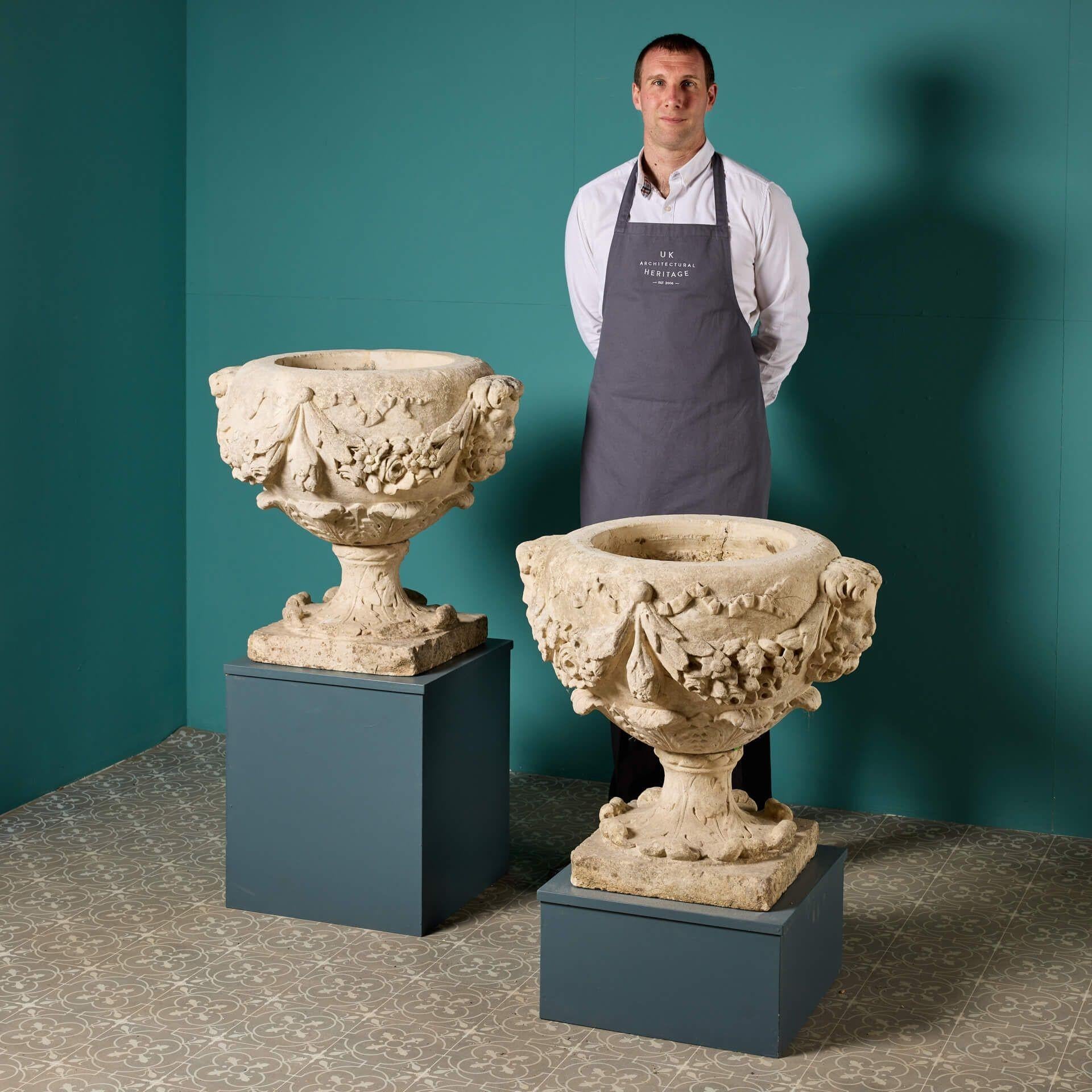 A pair of 240-year-old late 18th century English carved limestone garden urns from Aske Hall, North Yorkshire UK dispersed as part of a three day auction sale in 1994. Aske Hall is an English Georgian country house that originates from as early as