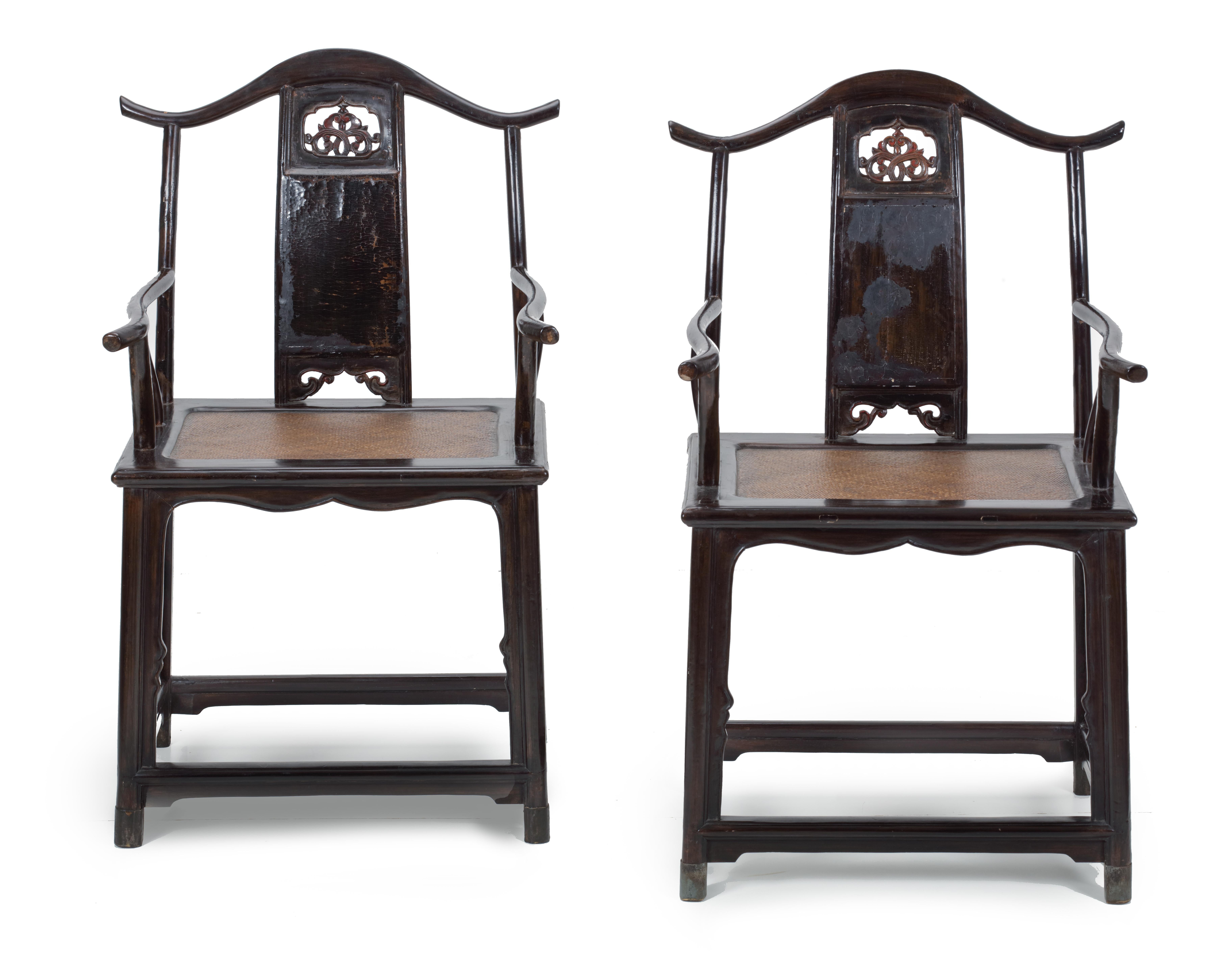 A pair of lacquered wood northern Chinese yoke-back chairs, Guan mao shi

Hebei Province, Qing Dynasty, early 18th century

Measures: H. 99.5 x W. 61 x D. 49 cm

?The back splats of the chairs, with rattan seating, are decorated with floral