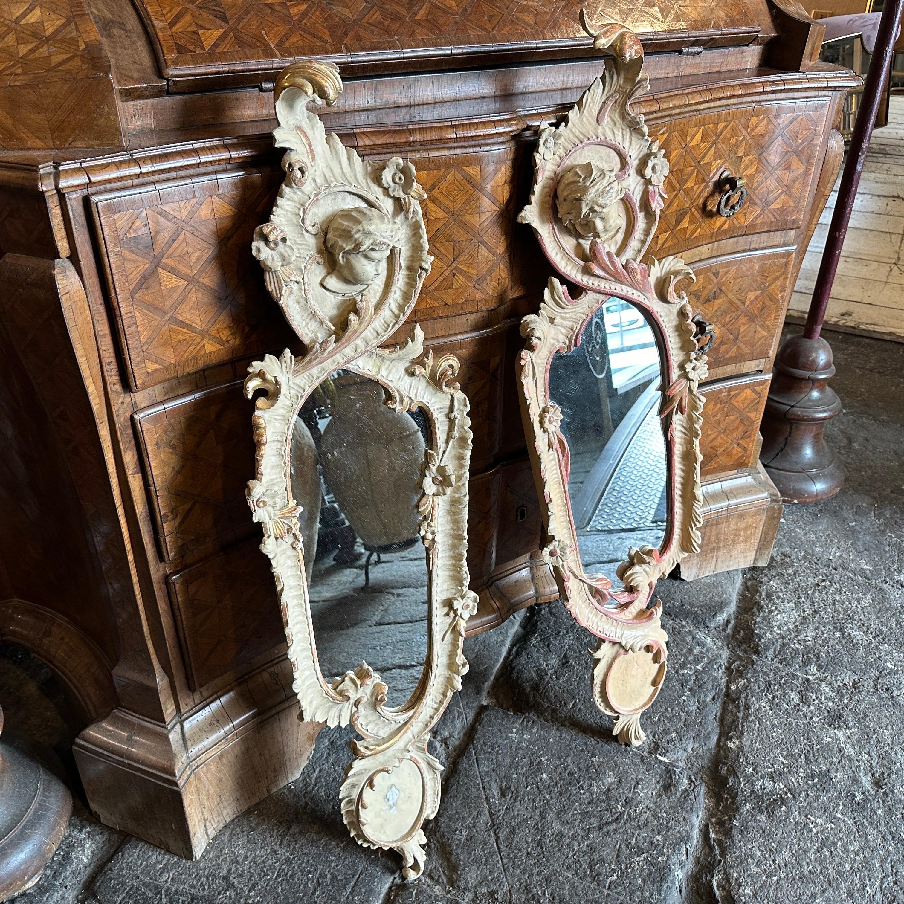 This set of two 1900s Art Nouveau hand-carved wood Italian wall mirrors is an exceptional example of artistic and functional design, the combination of intricate carvings, fluid organic shapes, and a luxurious lacquered finish would showcase the