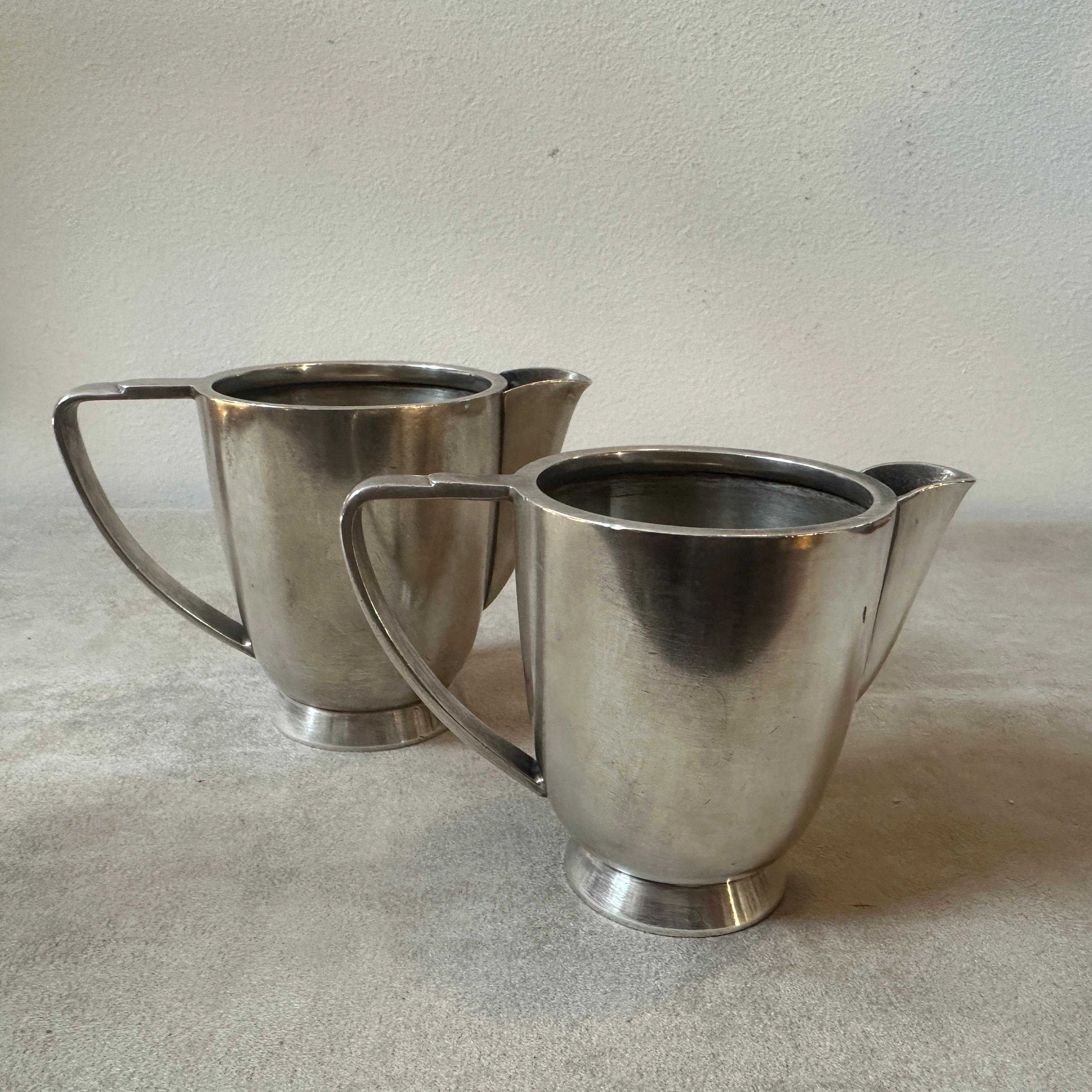 A set of two alpaca coffee pot designed by Gio Ponti and manufactured by Fratelli Calderoni in the Forties, they were used in the hotels and they are marked on the bottom Fratelli Calderoni, they are in original conditions with normal signs of use