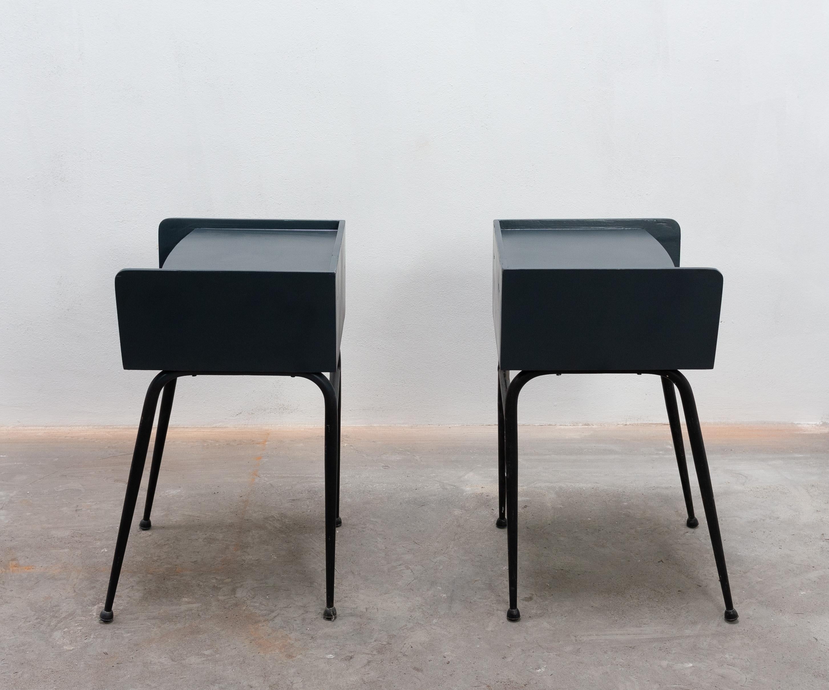 Two elegant nightstands. Tubular metal legs with an anthracite plywood top, 1950s.