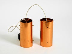 Two 1950s tube pendant lamps consisting of two screwed-together copper bowls