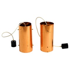 Two 1950s tube pendant lamps consisting of two screwed-together copper bowls