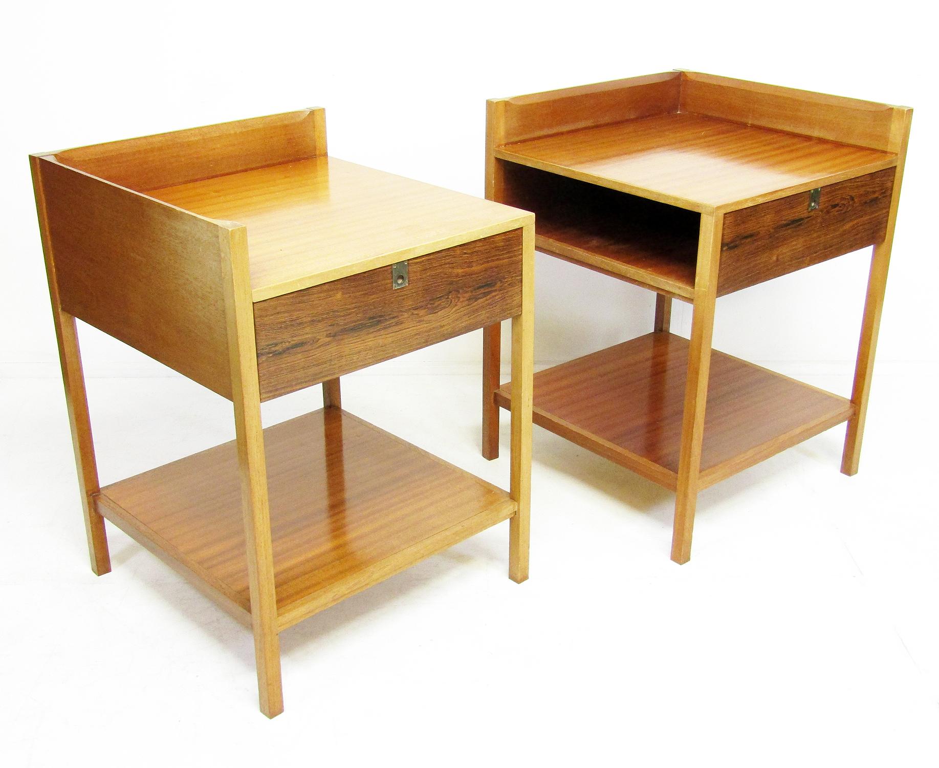 A pair of 1960s bedside or lamp tables in Rio rosewood and mahogany, with brass campaign pulls, probably sold by Heals.

Of generous proportions, the storage sections have flip-down front doors in rosewood, but also allow open bedside