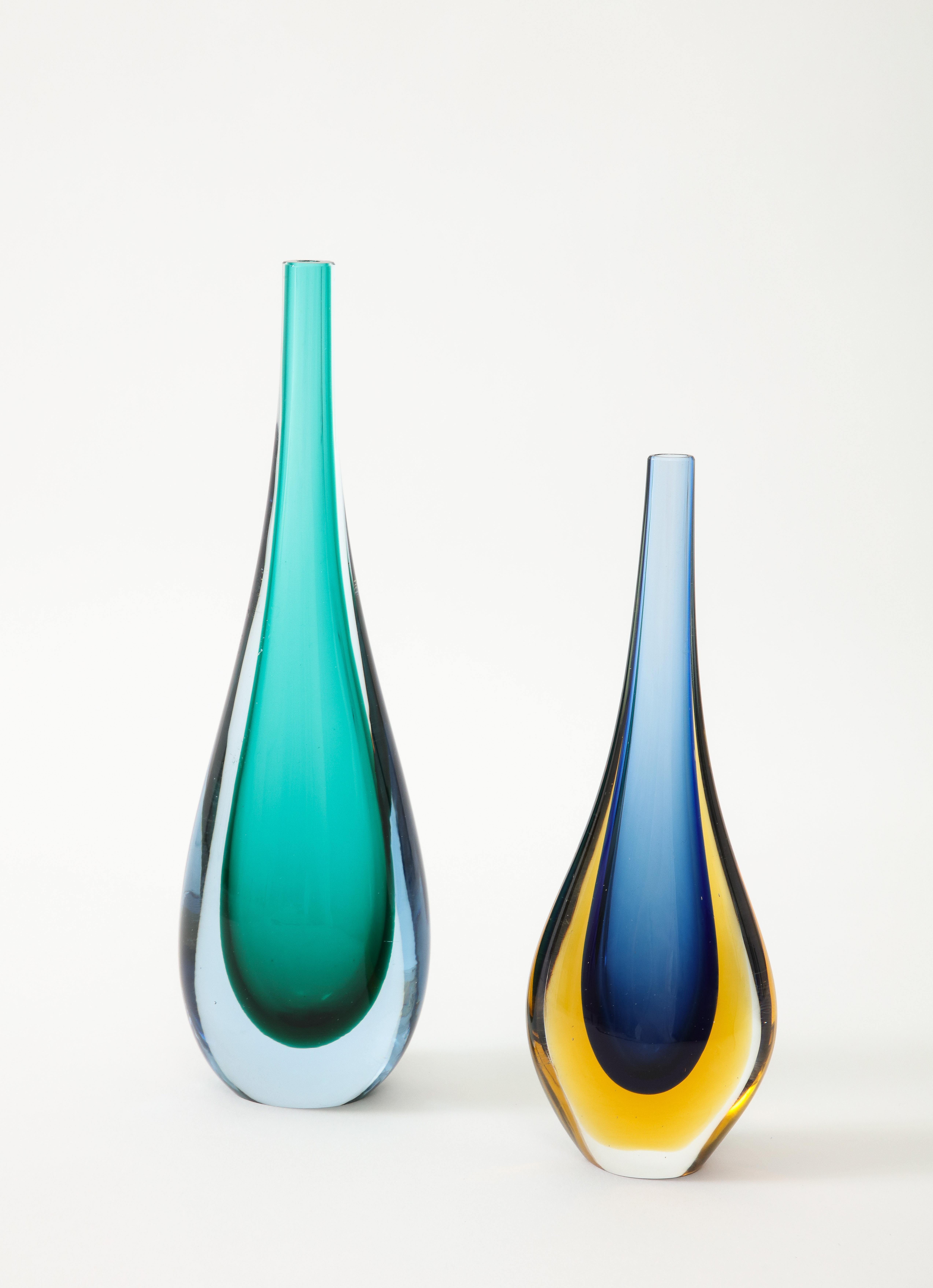 Two beautiful  1960's Sommerso hand blown Murano glass tear drop vases with
long necks.
The wonderful contrasting colors between the Blue and Yellow vase is Exquisite in person, and pairs very nicely with the Green one.
The Larger Green vase is