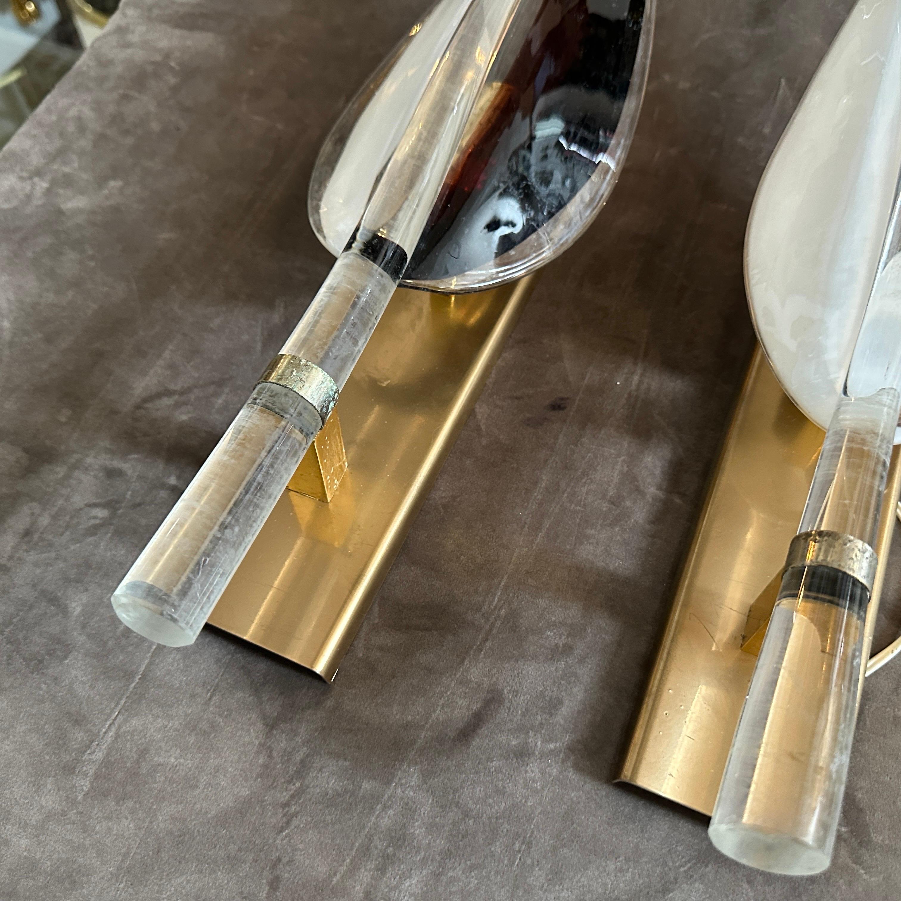 These huge 1970s Mid-Century Modern Murano glass wall sconces by Franco Luce are a stunning example of Italian craftsmanship and avant-garde lighting design. Each sconce features an elongated, flame-like Murano glass shade, gracefully tapering to a