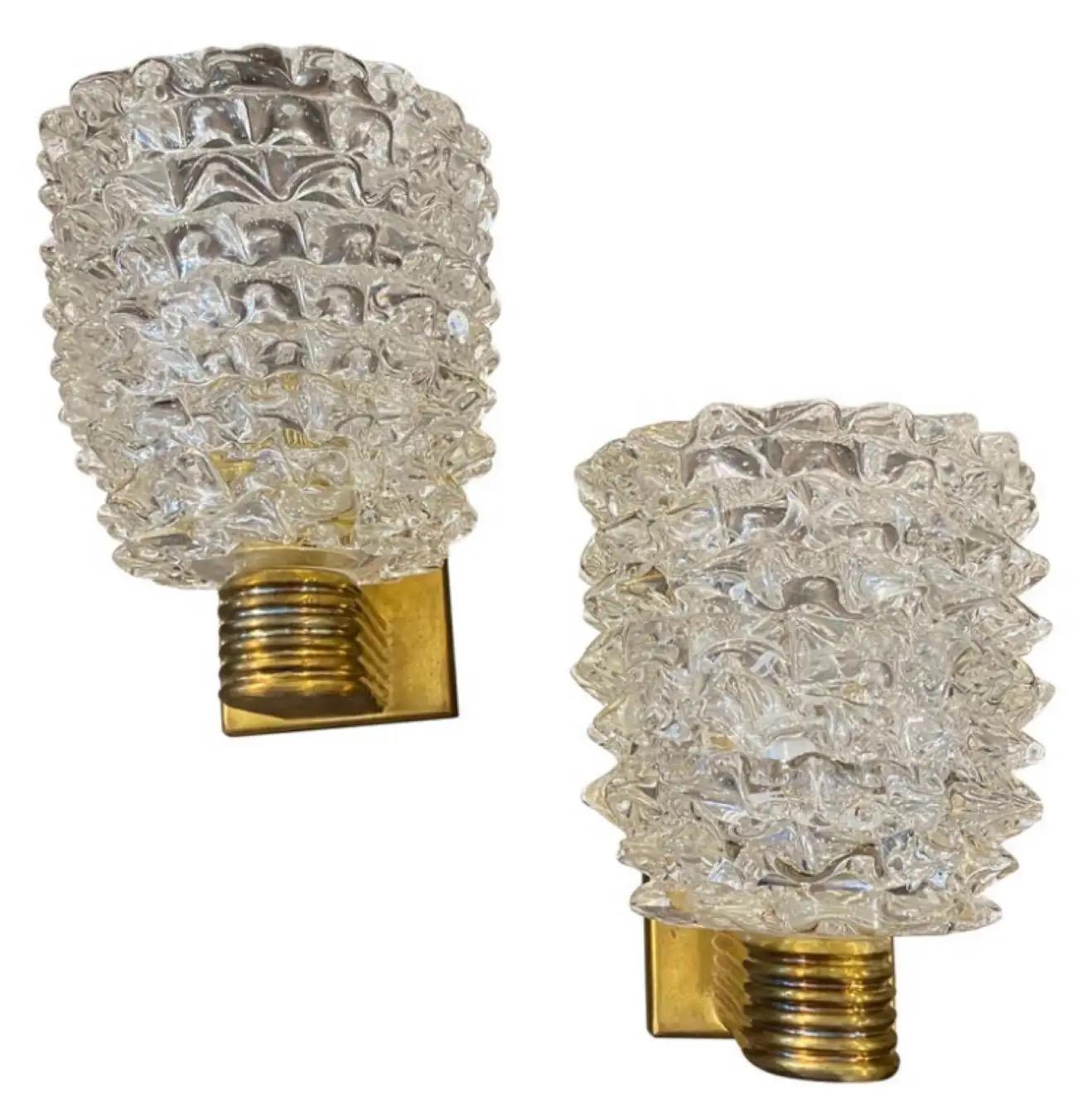 A pair of wall lights designed and manufactured in Italy in the style of Barovier, which invented this particular glass processing technique named Rostrato characterized by large light-reflecting points. These points are obtained through a