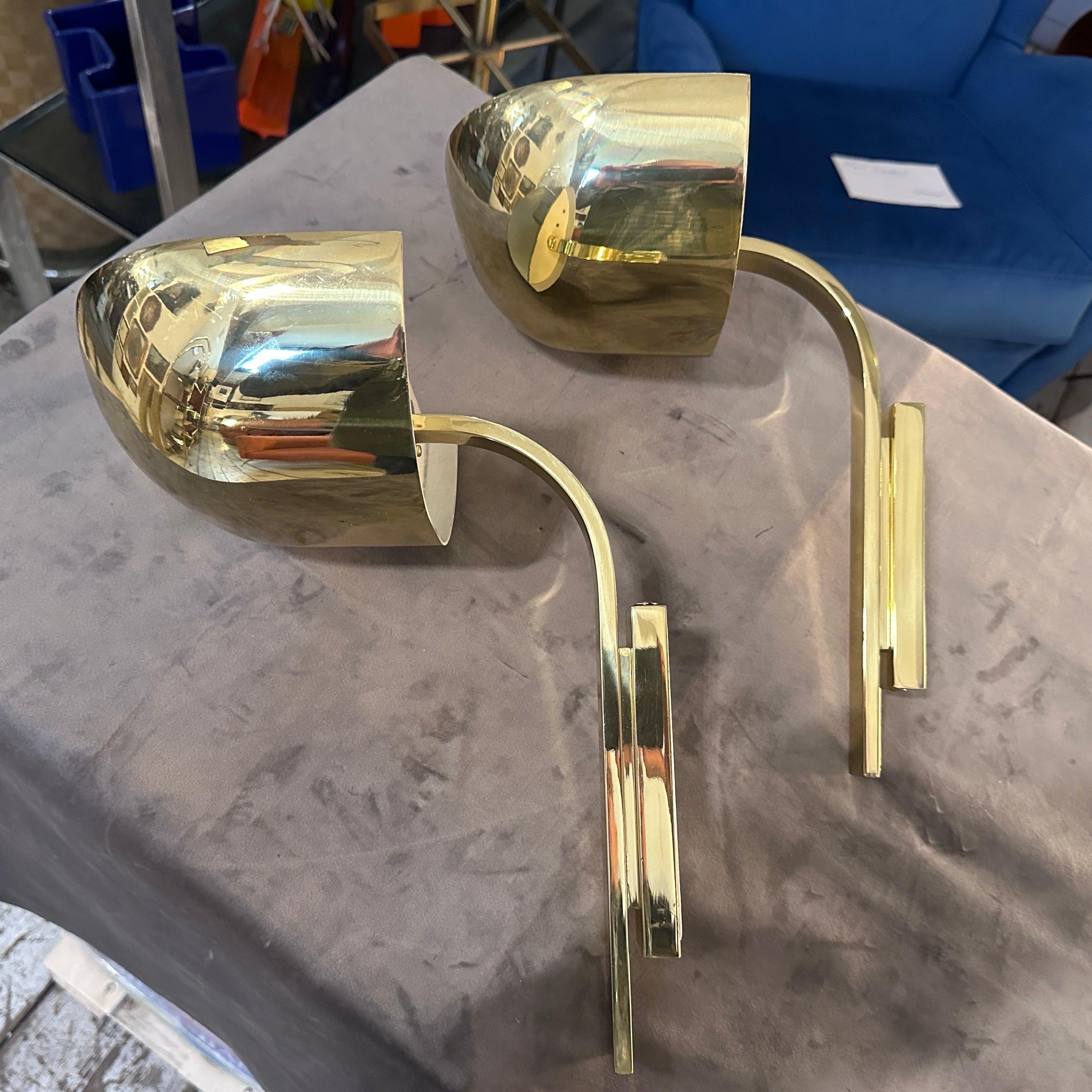 A pair of high quality solid brass wall sconces designed and manufactured in Italy in the Eighties by Lumi. They are in lovely conditions and have the logo embossed on the inside. The Wall Sconces by Lumi Milano are exquisite lighting fixtures that