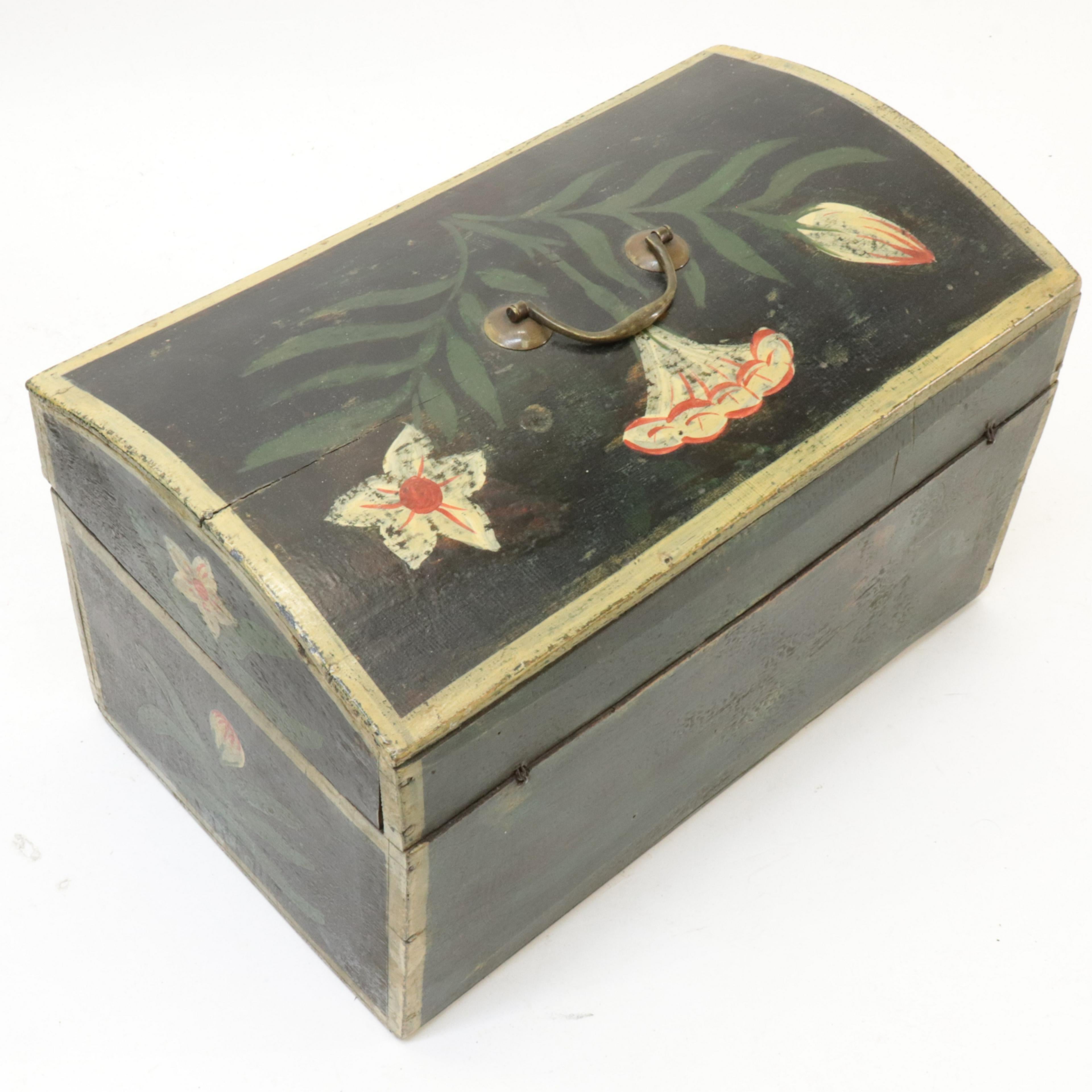 Two early 19th century French Folk Art painted dome-top wedding boxes in beech, decorated with painted flowers, swags, hearts and other motifs. These were traditional filled with linens and other soft goods and given to a bride onher wedding
