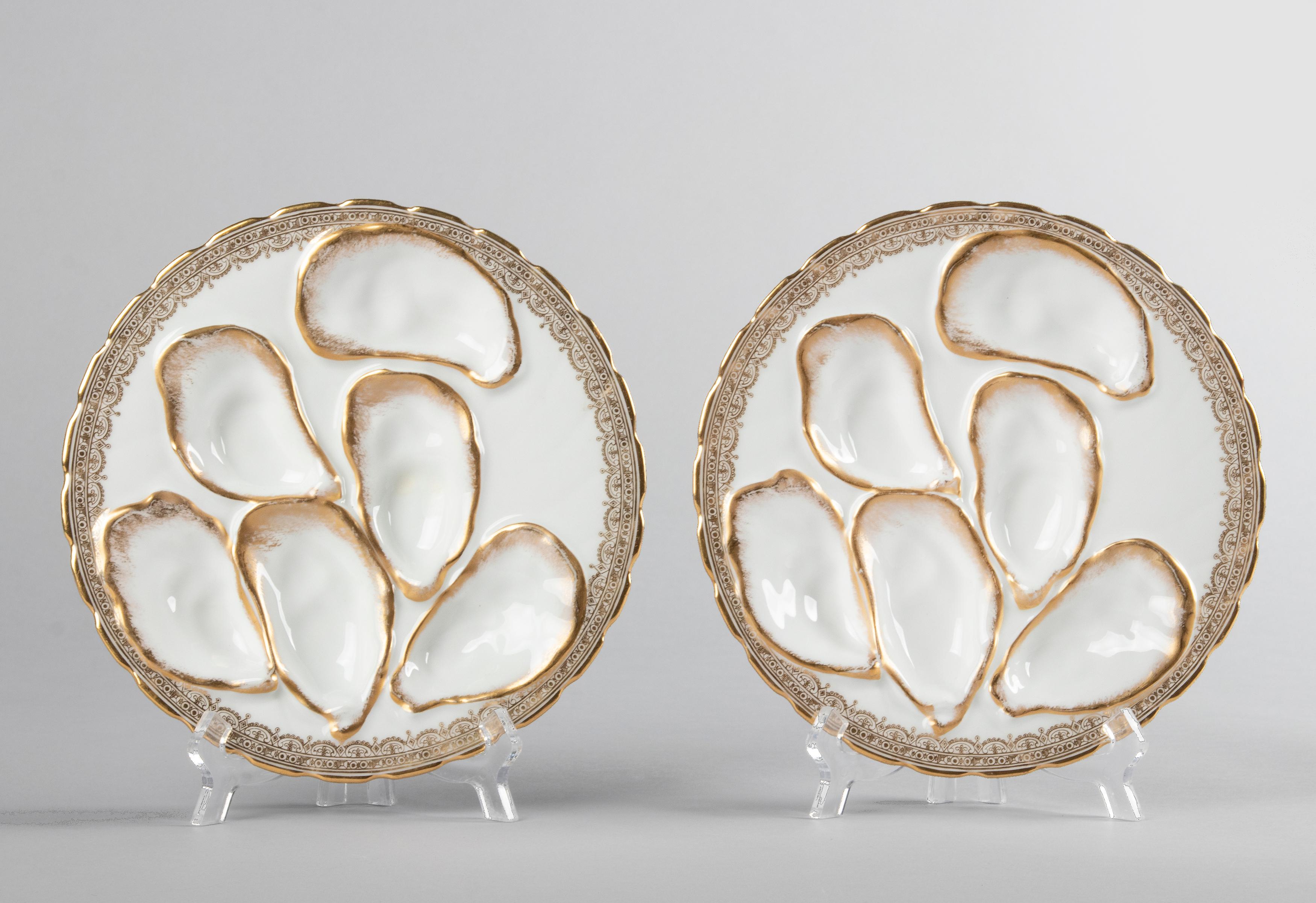Two beautiful antique oyster plates by the French maker Haviland Limoges. The plates are snow white in color with hand-painted gold accents. The plates have a beautiful relief work with space for 6 oysters per plate. What is special about these
