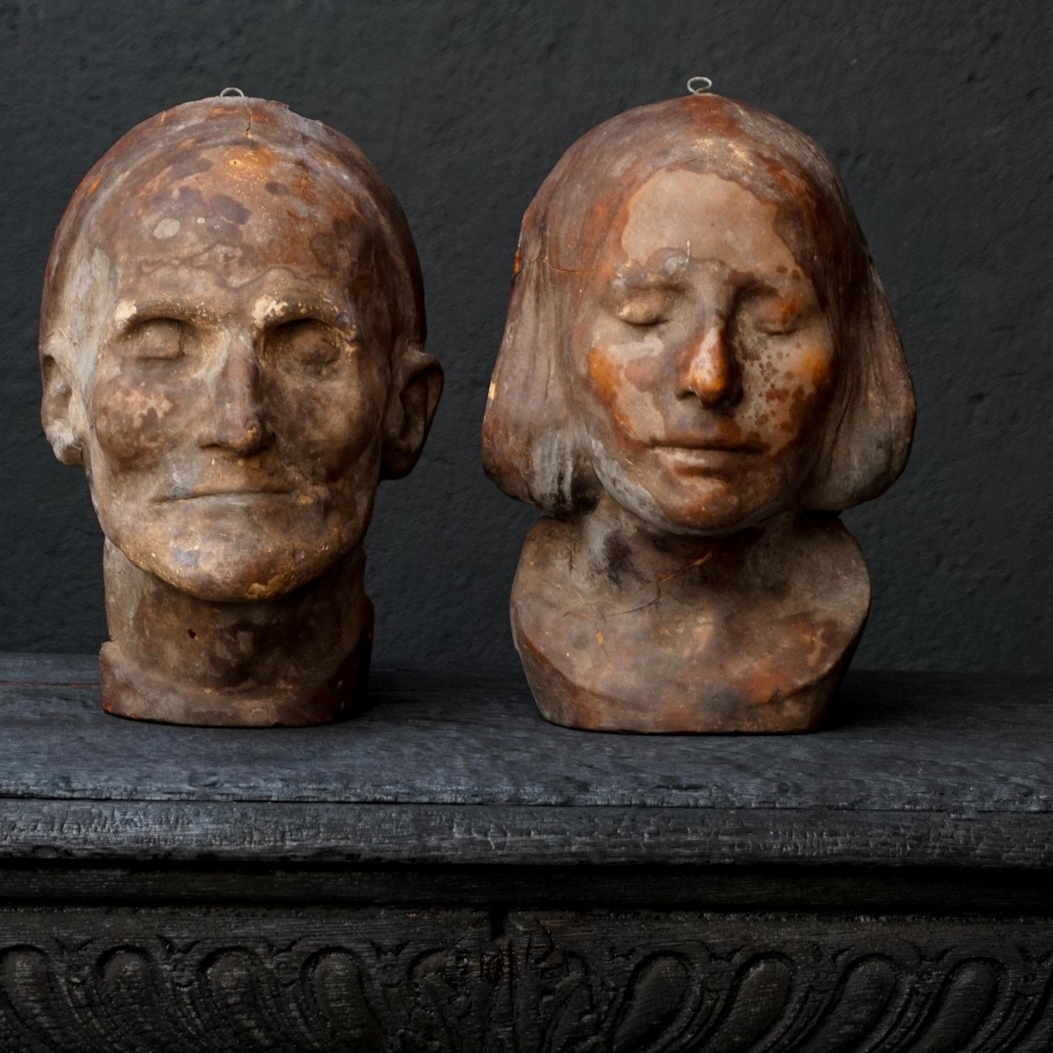 Beautiful anonymous wax death masks, depicting an older male and a young woman. 
The young woman mask strikes a resemblance with the 'L'Inconnue de la Seine' death mask. The Unknown Woman of the Seine, was an unidentified young woman whose putative